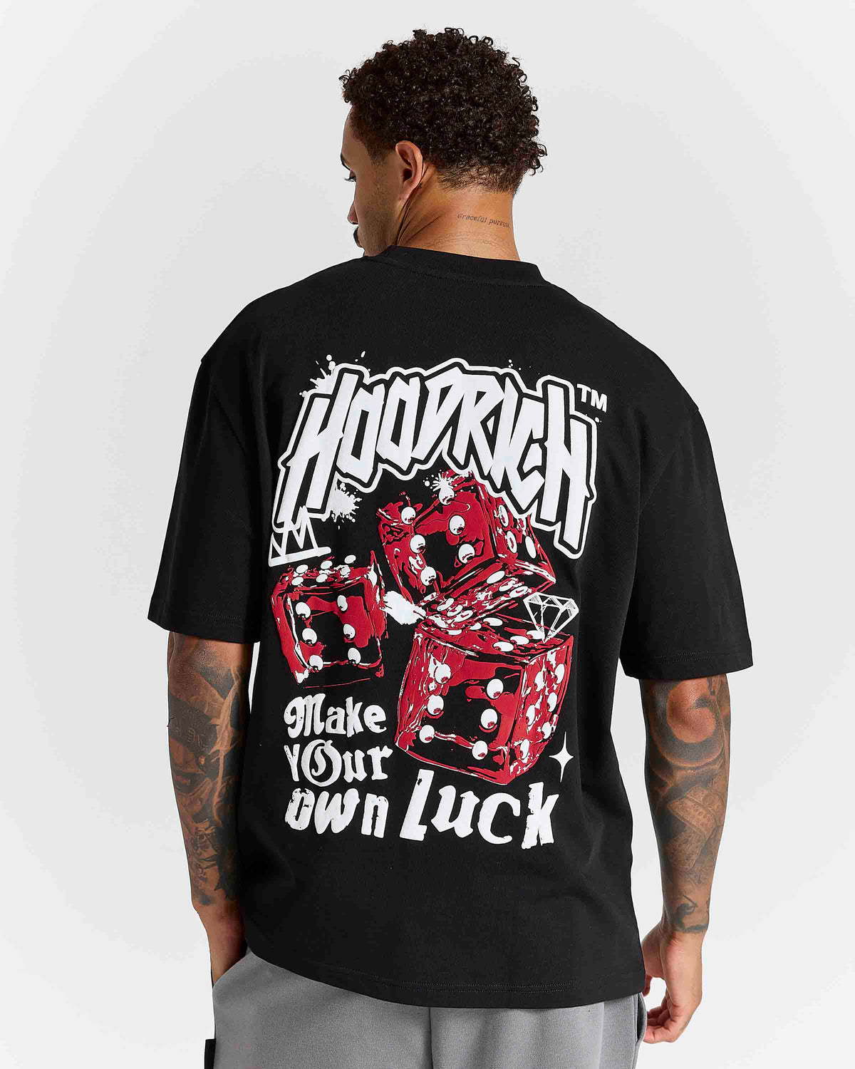 Displays a model wearing the Black 'Hoodrich' branded Fortune Oversized T-Shirt