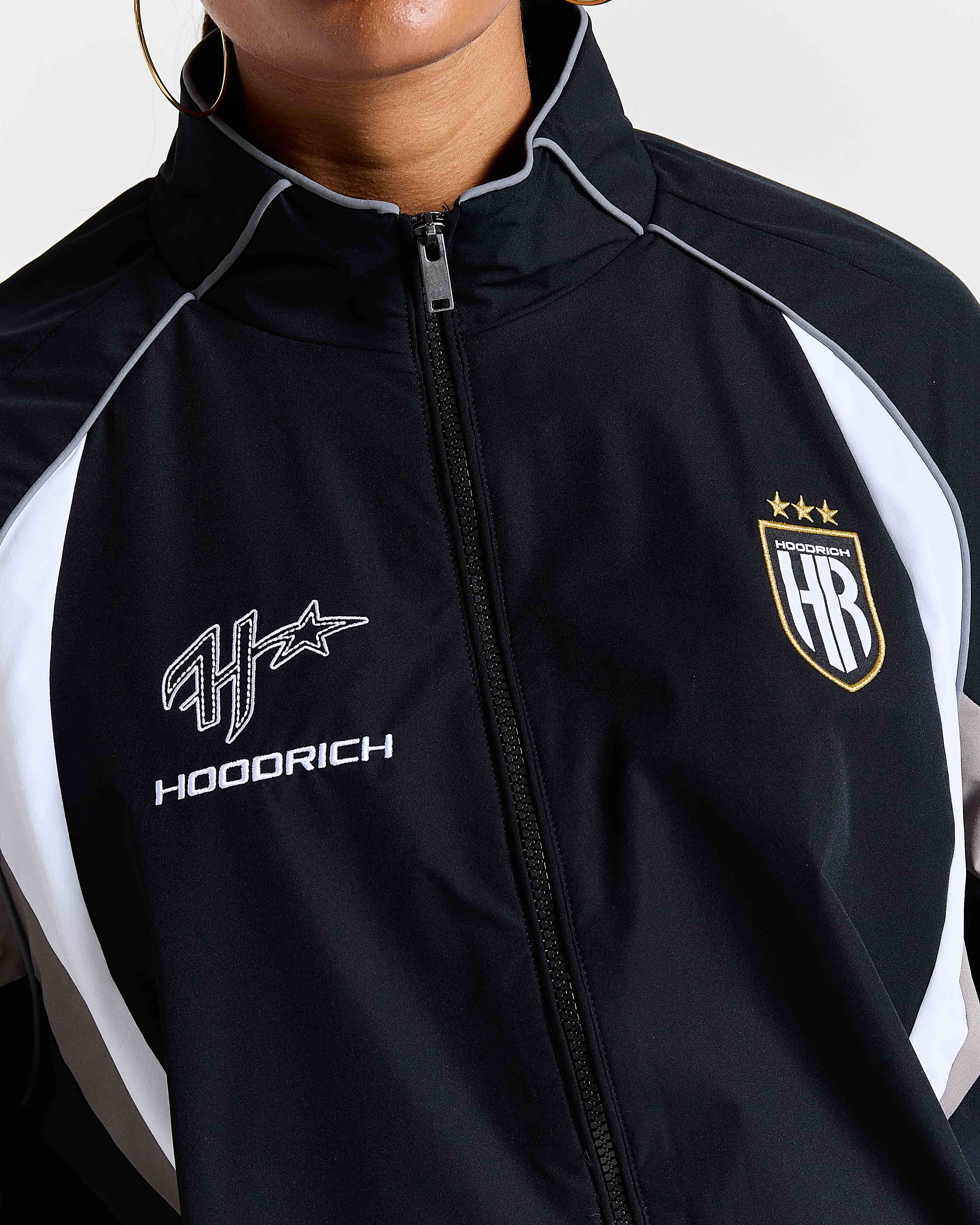 Black and white jacket with 'Hoodrich' logo on a plain background
