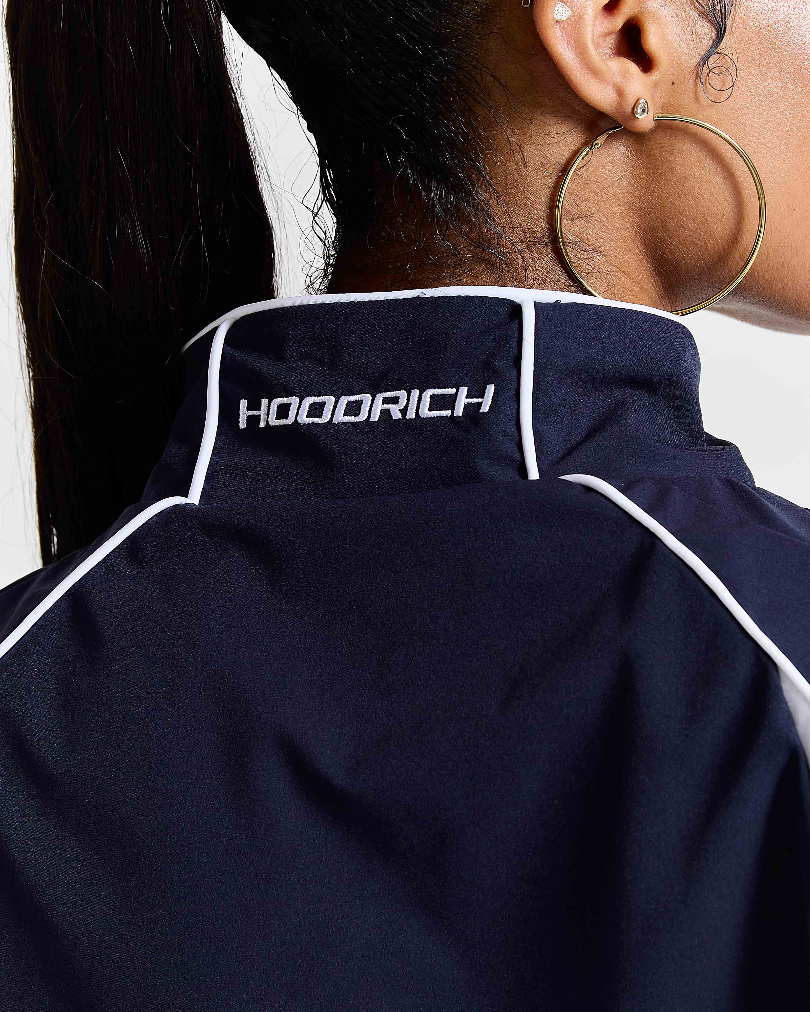 Navy blue jacket with 'HOODRICH' branding on a plain background