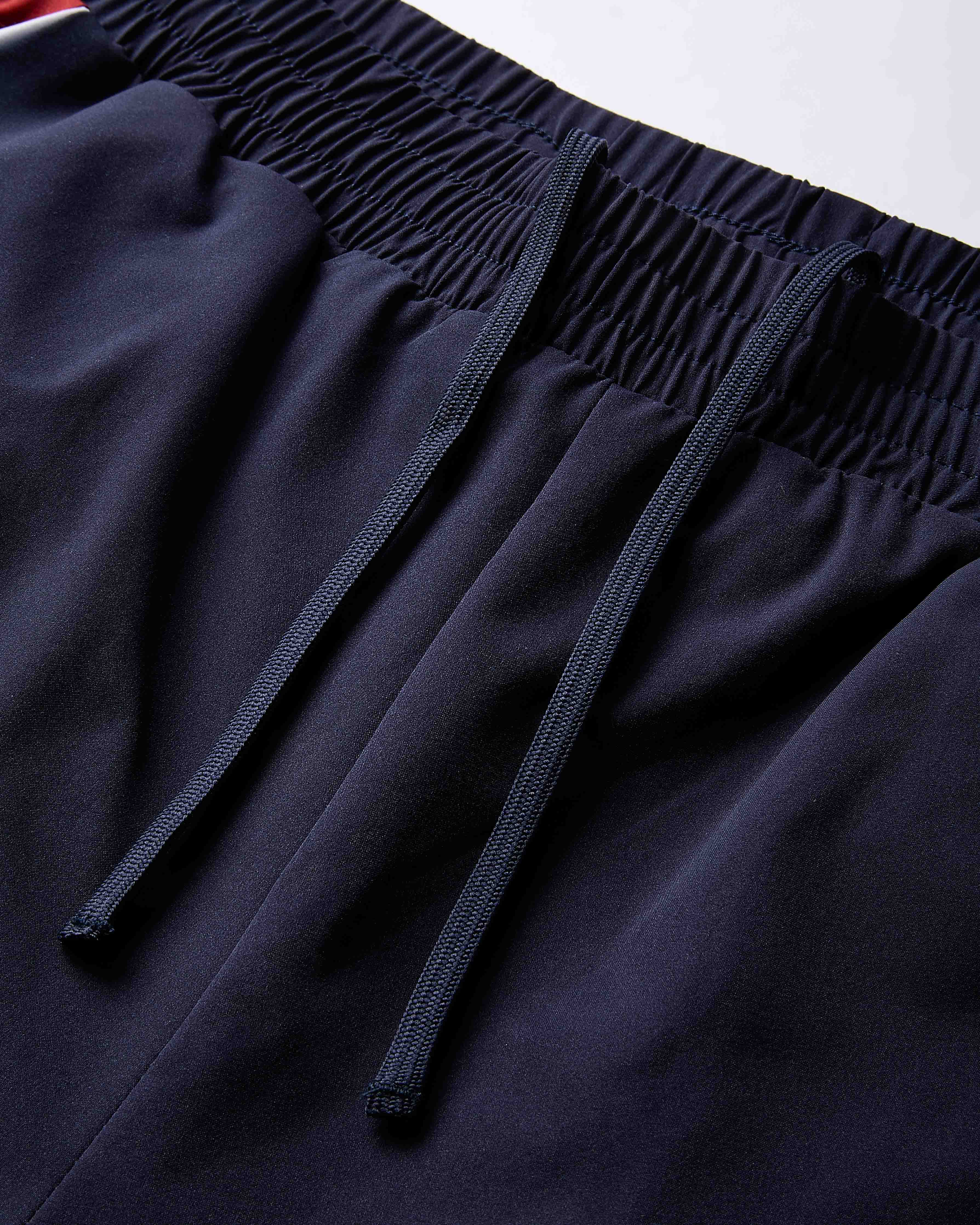 Close-up of dark blue pants with an elastic waistband on a white background