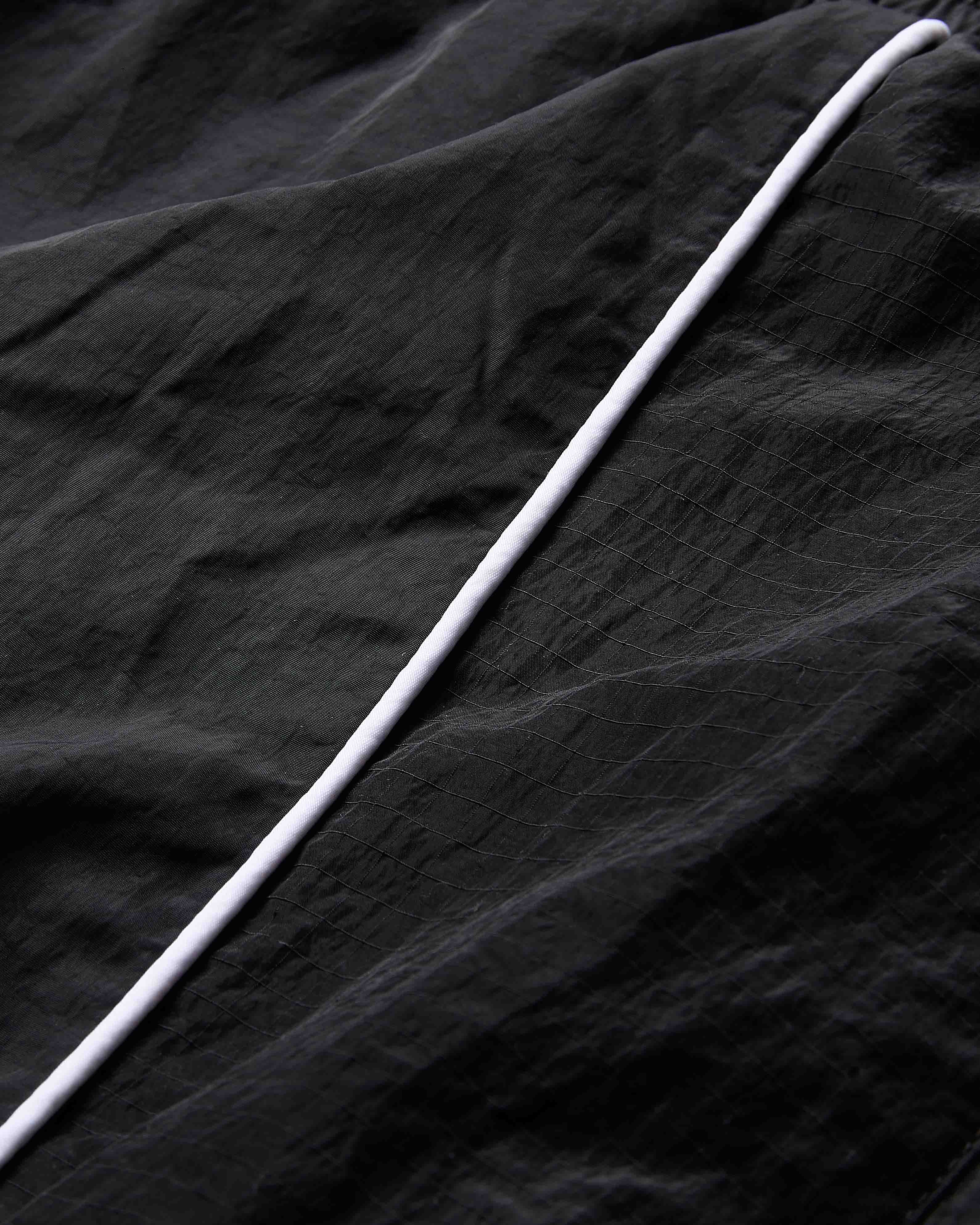 White cable on a black textured fabric background