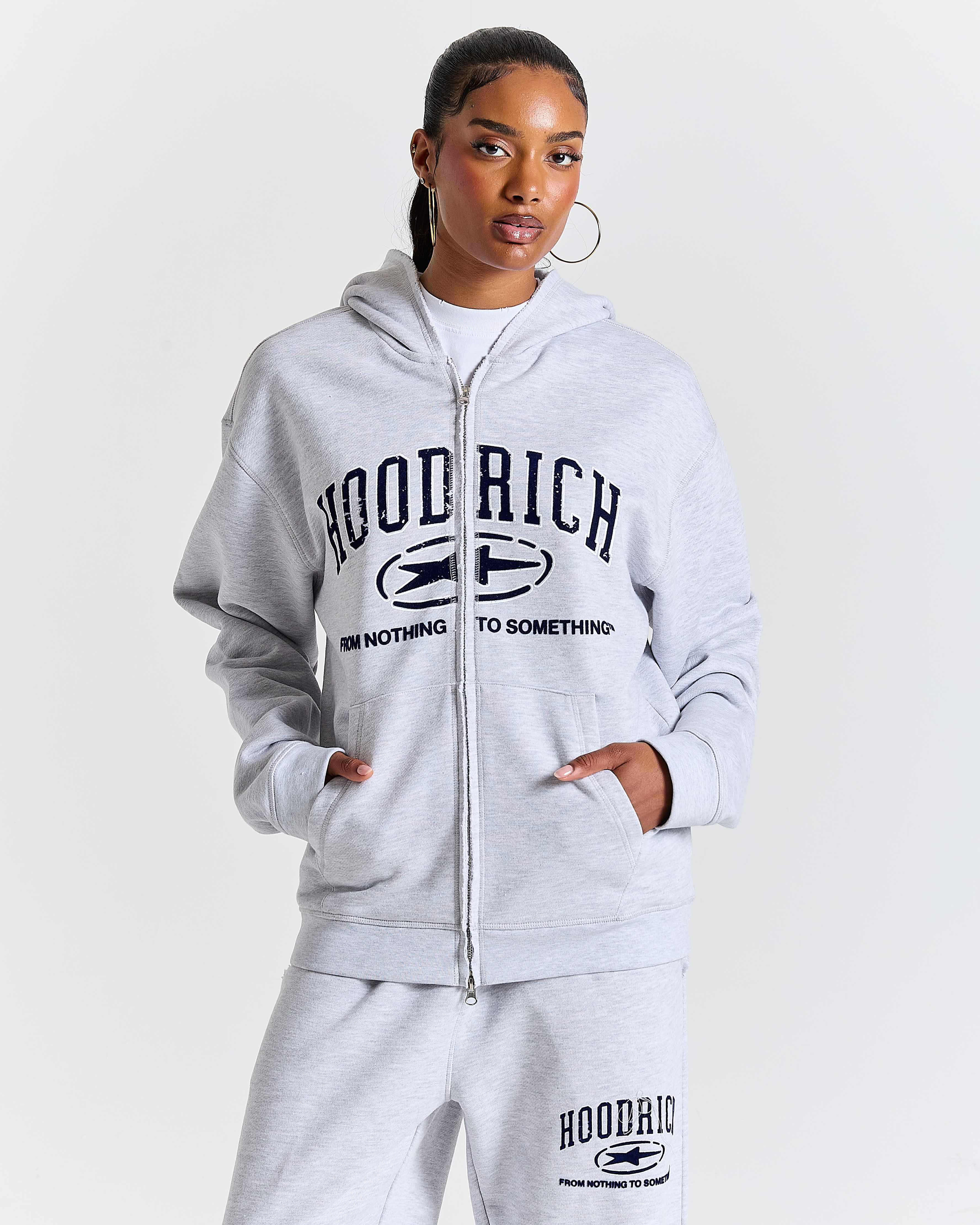 Displays a model wearing the Grey 'Hoodrich' branded Women's Frey Full Tracksuit
