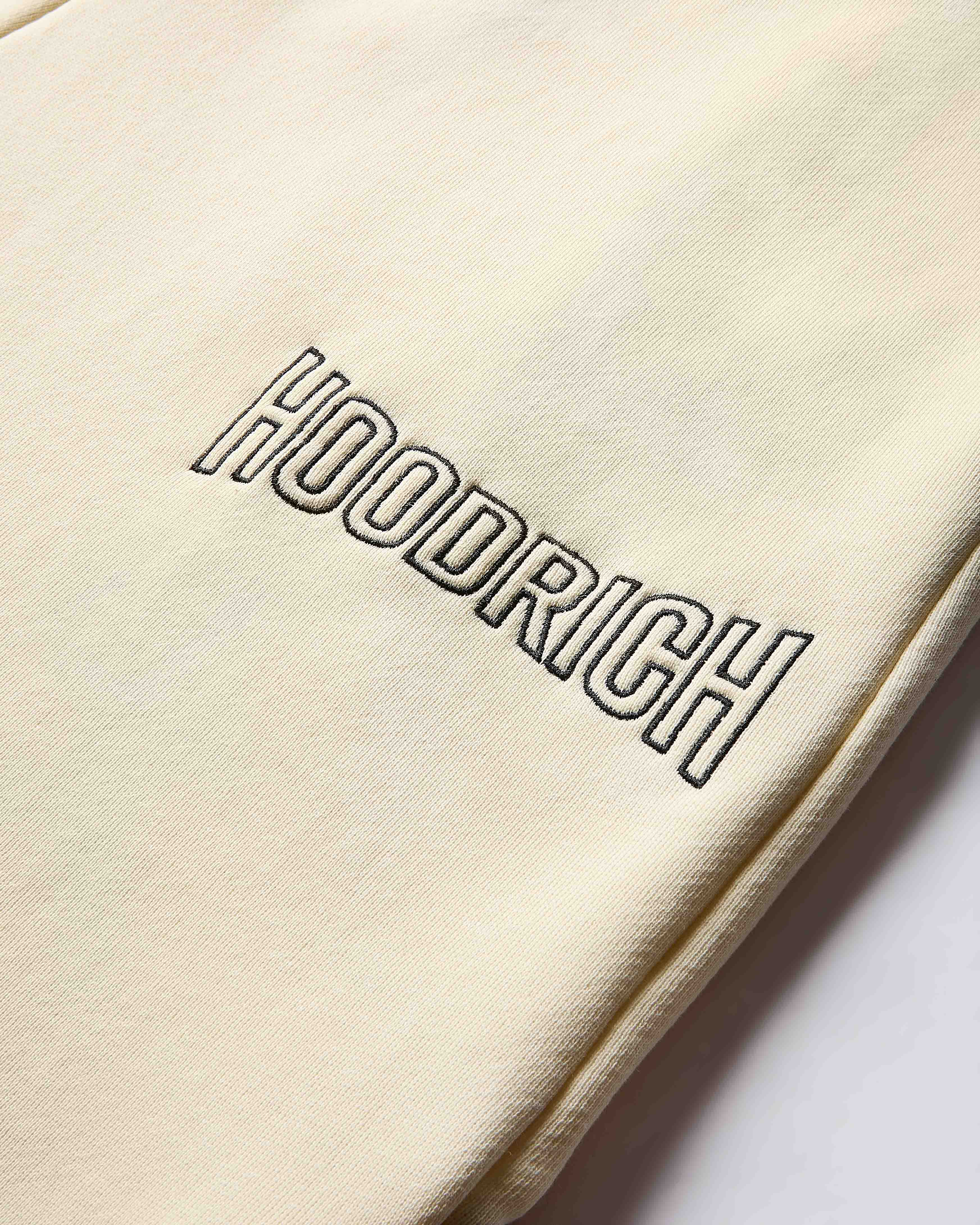Beige fabric with 'HOODRICH' embroidered on it