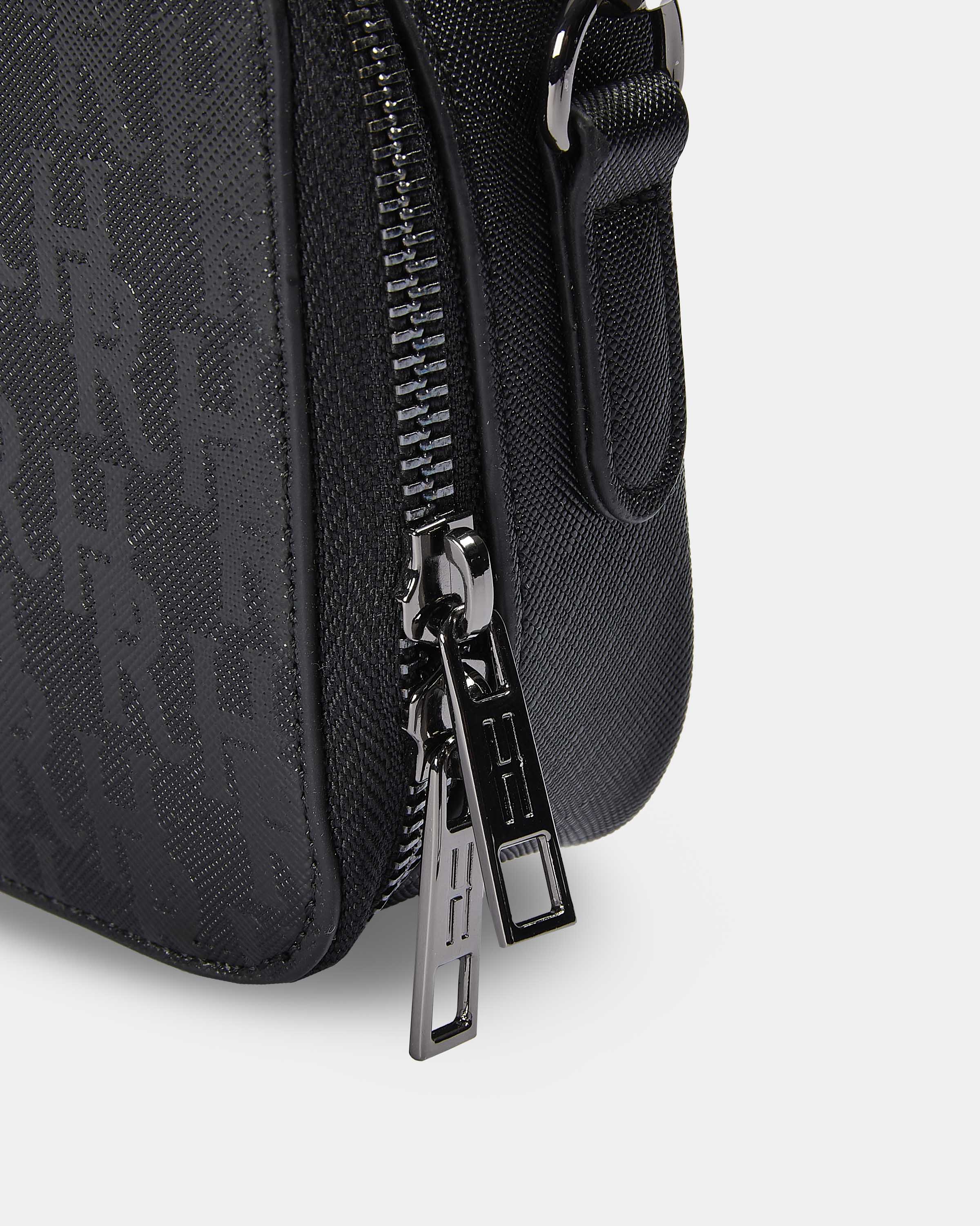Black textured bag with a zipper on a light gray background