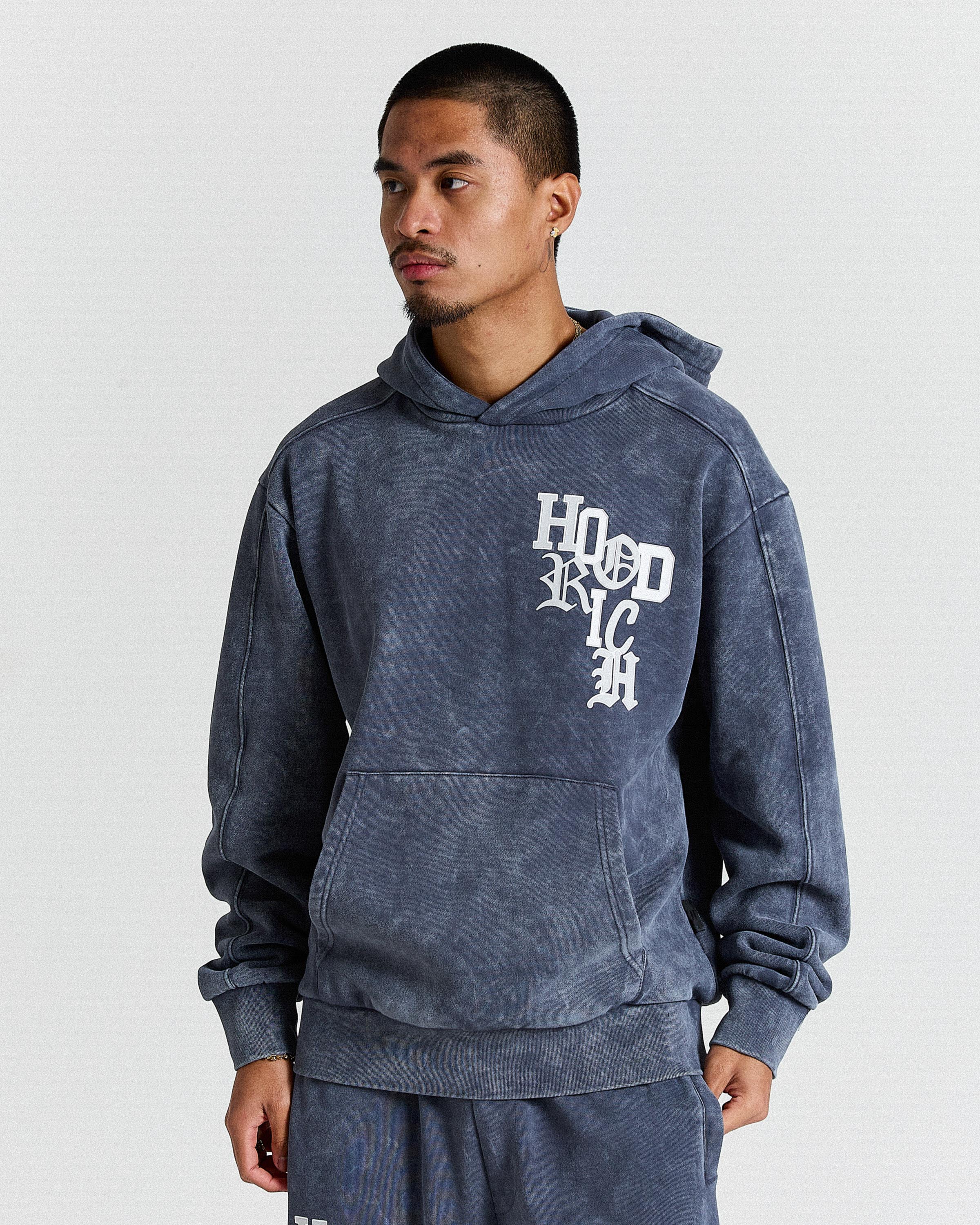 Man wearing a blue hoodie with text on a gray background