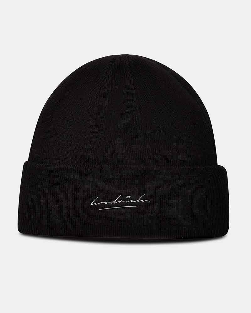 A black knit beanie hat with a folded cuff, featuring a small white embroidered script logo of Hoodrich on the front.