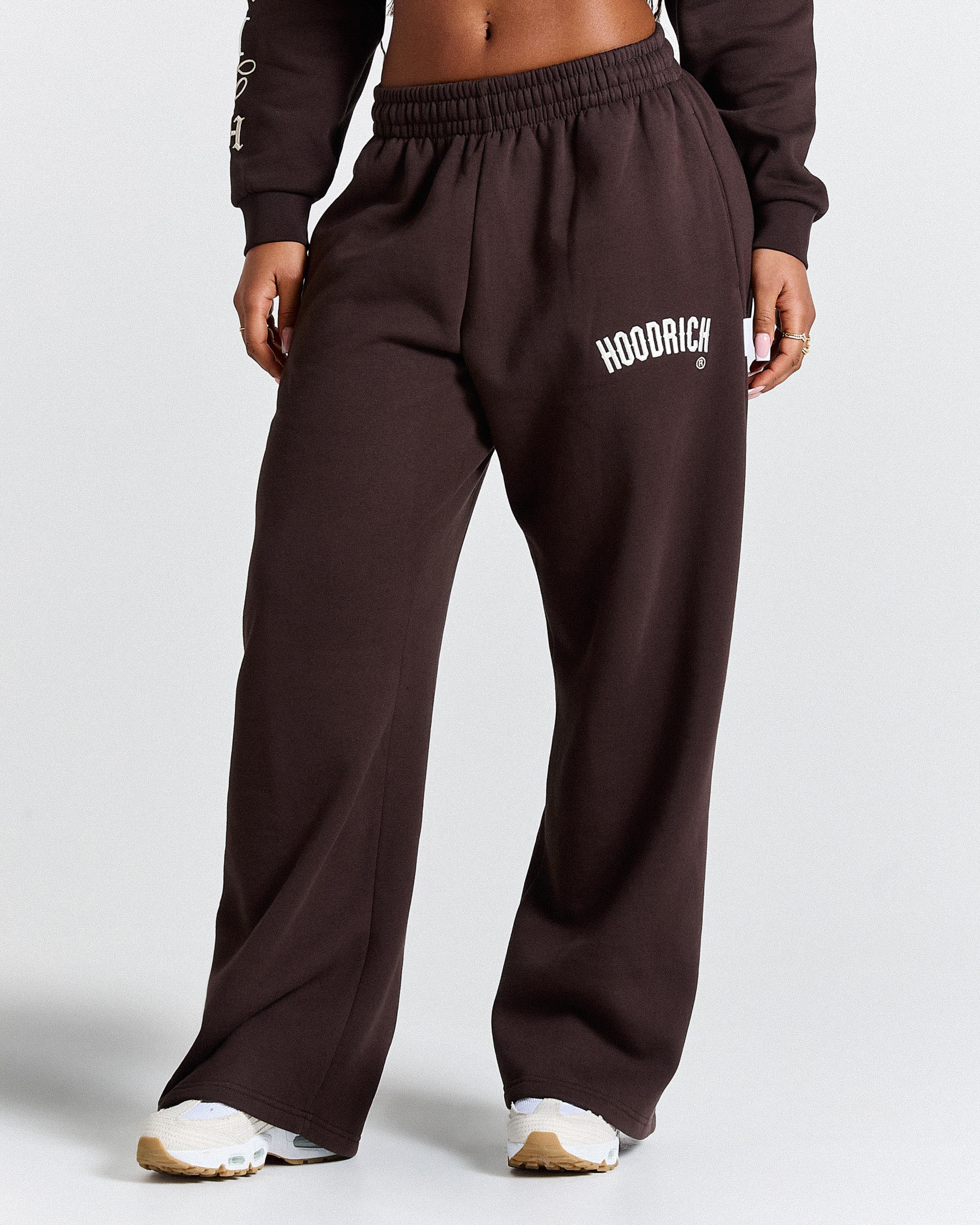 Brown sweatpants with 'Hoodrich' branding on a white background