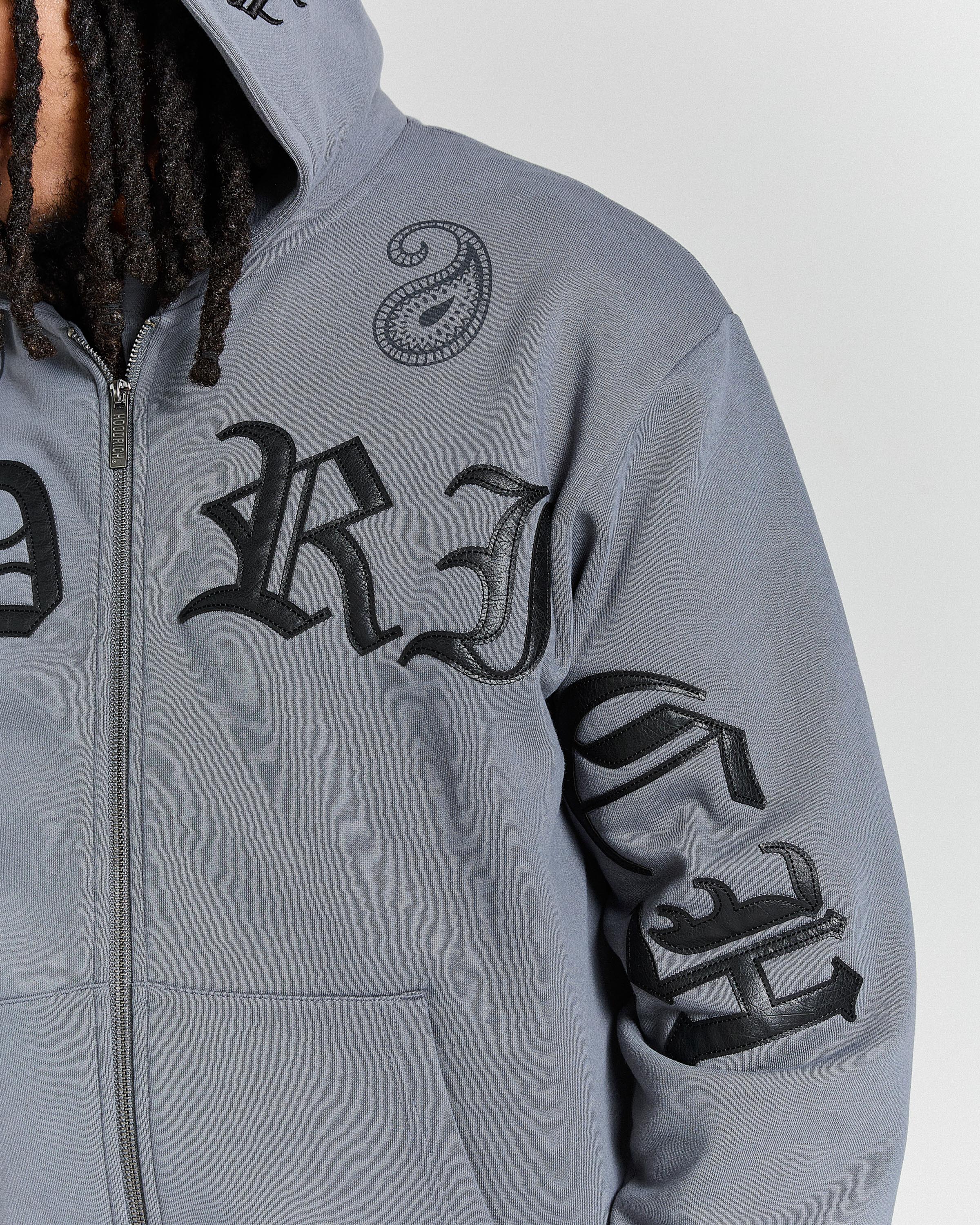 Gray hoodie with black lettering and designs on a plain background