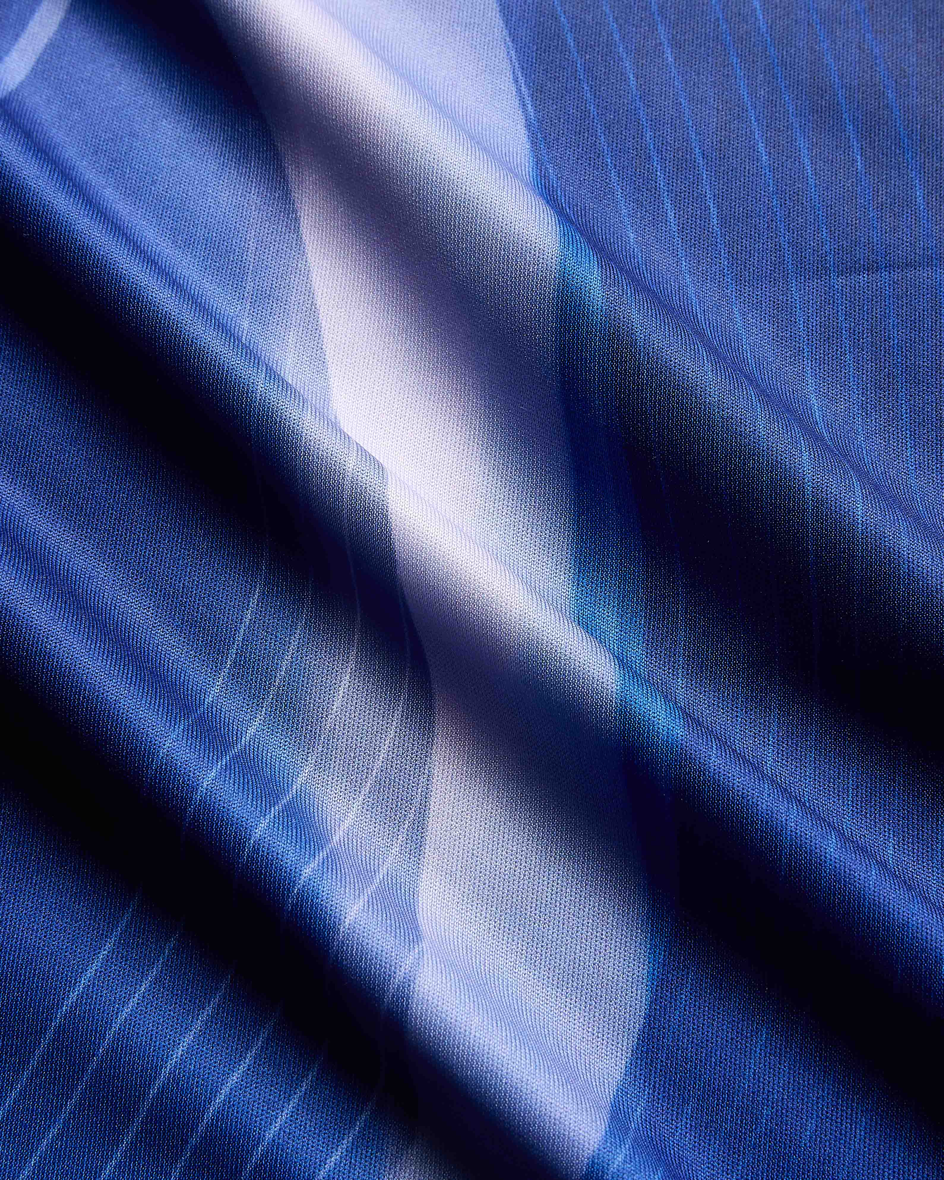 Close-up of blue fabric with a subtle pattern