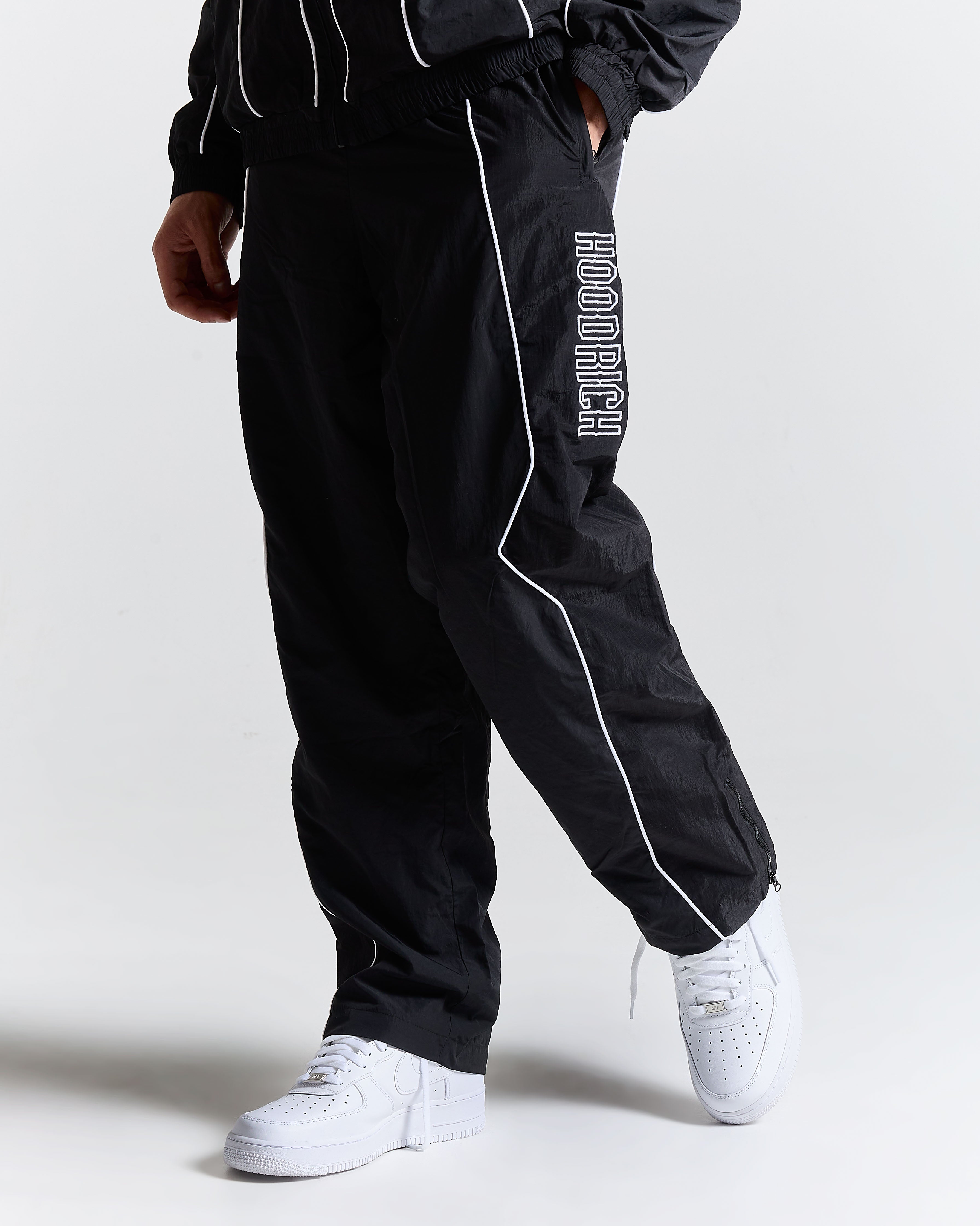 Black tracksuit with 'Hoodrich' branding on a white background