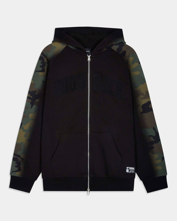 A black zip-up hoodie with camouflage patterned raglan sleeves and a tonal black 'HOODRICH' logo across the chest, displayed on a light gray background.