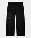 Black wide-leg sweatpants with a drawstring waistband and a tonal vertical 'HOODRICH' logo printed on the left leg, shown against a light gray background.