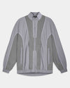 A gray zip-up jacket with a subtle grid pattern on the sleeves and front panels, featuring white piping details and a high collar, shown against a light gray background.