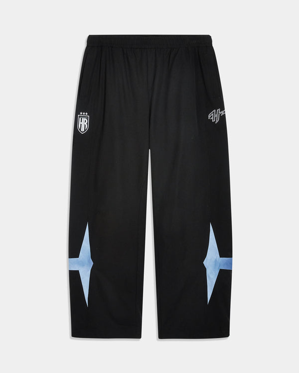 Black athletic sweatpants with white printed graphics on the upper thighs and light blue starburst shapes on the lower legs, shown flat against a light gray background.