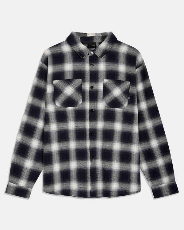 A long-sleeve button-up flannel shirt with a black and white plaid pattern, featuring two buttoned chest pockets, shown against a light gray background.