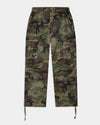 A pair of camouflage cargo pants with a green, brown, and black camo pattern, featuring a drawstring waist and hem, and a small black embroidered logo on the right thigh.
