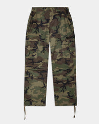 A pair of camouflage cargo pants with a green, brown, and black camo pattern, featuring a drawstring waist and hem, and a small black embroidered logo on the right thigh.