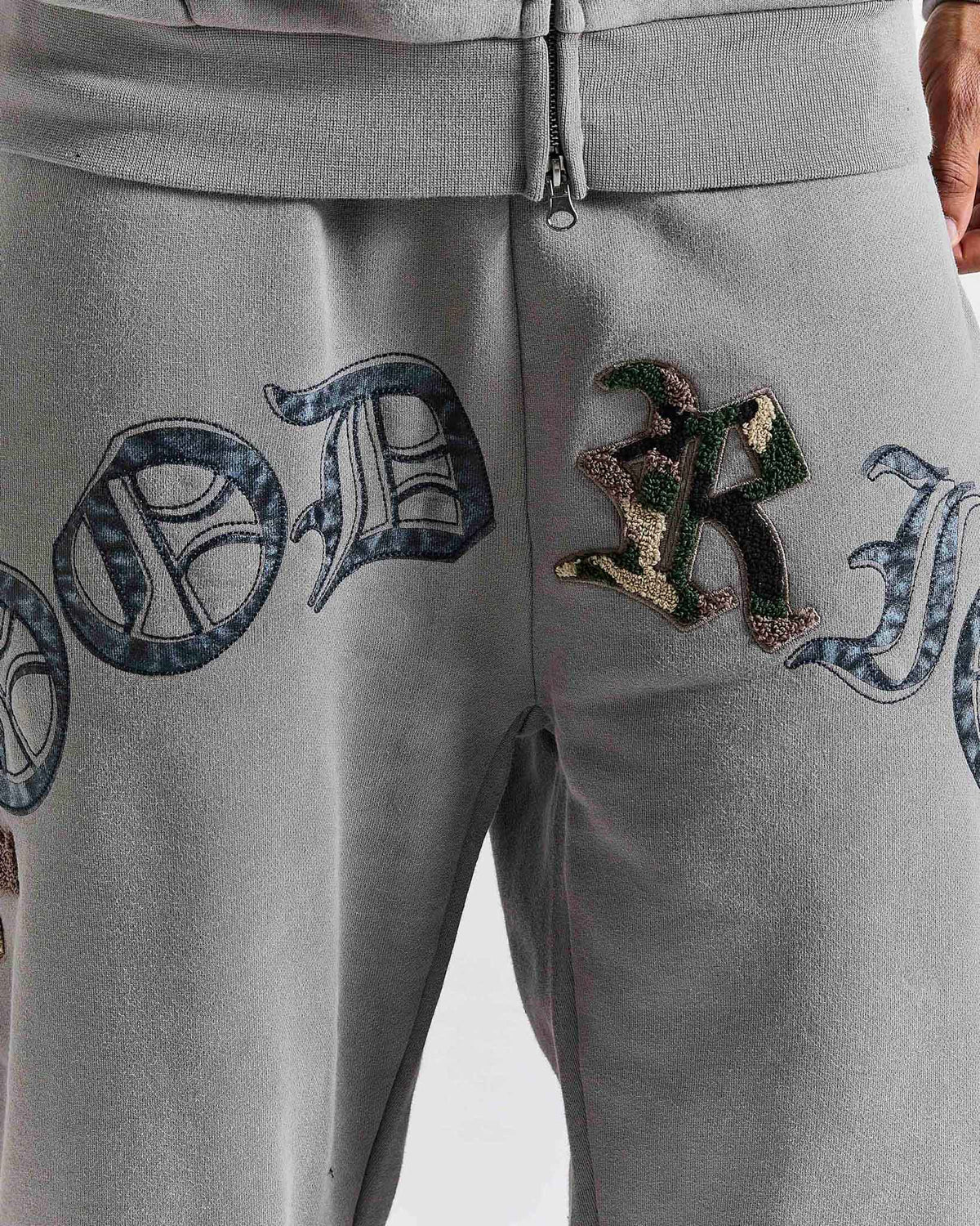 Displays a model wearing the Grey 'Hoodrich' branded men's Inkfall Full Tracksuit featuring the hoodrich branding