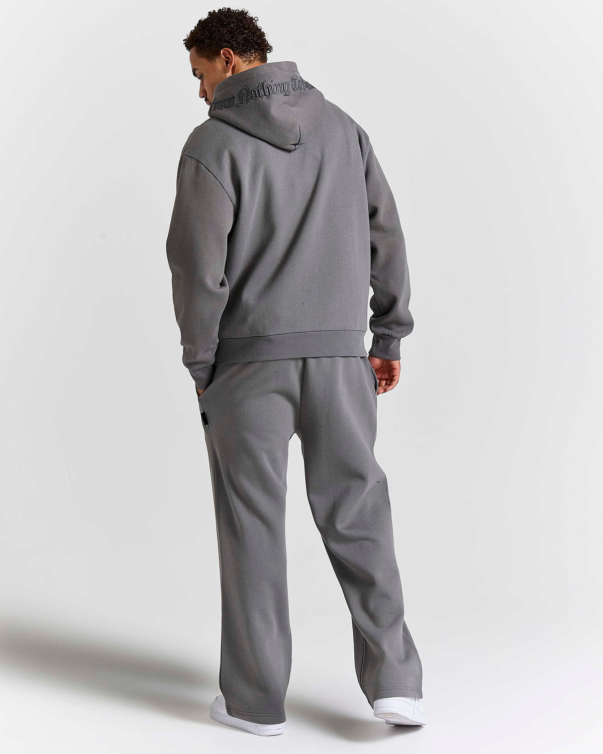 Displays a model wearing the grey lava smoke 'Hoodrich' branded Forza Oversized Wide Leg Jogger 