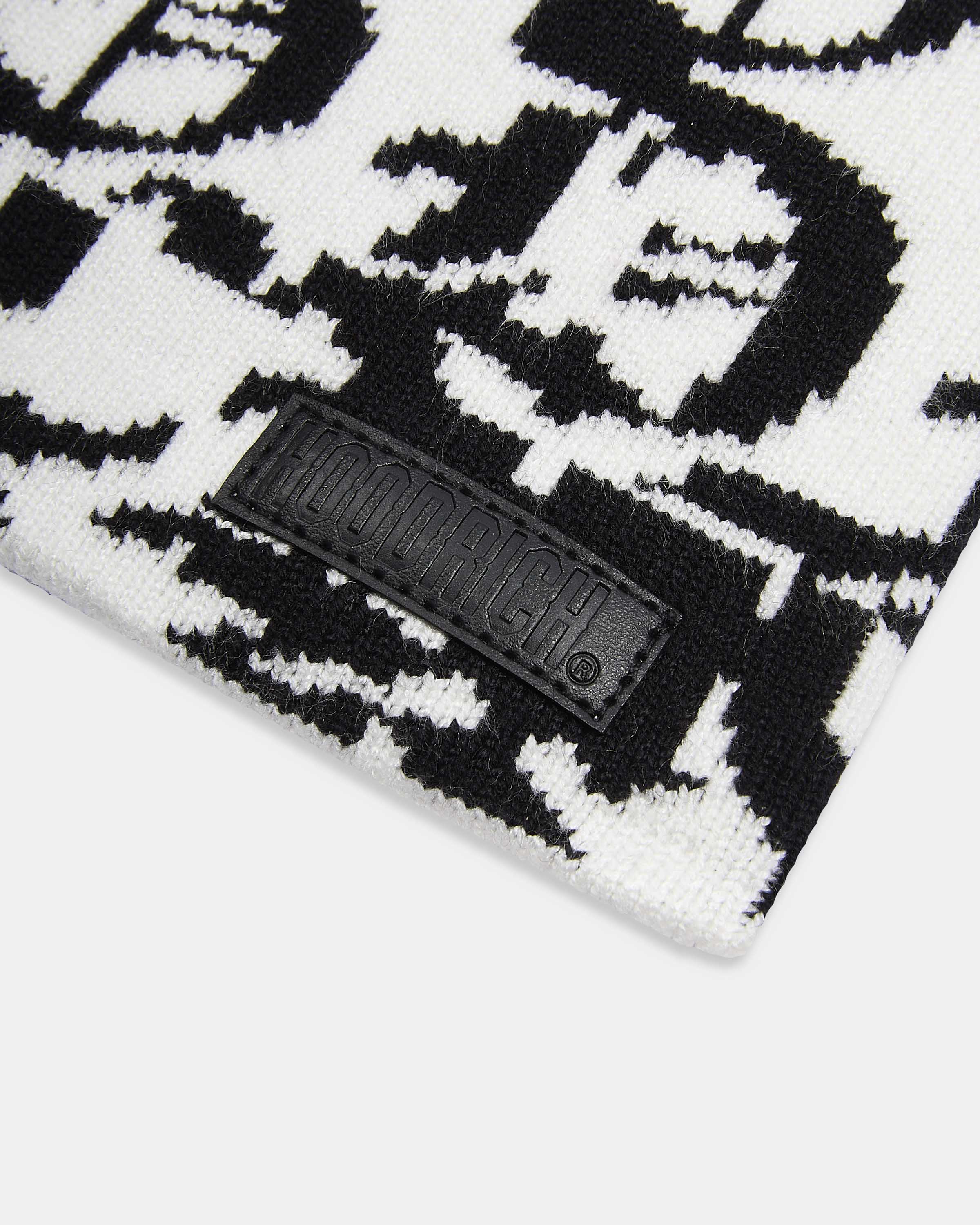 Black and white patterned fabric with a brand logo tag.