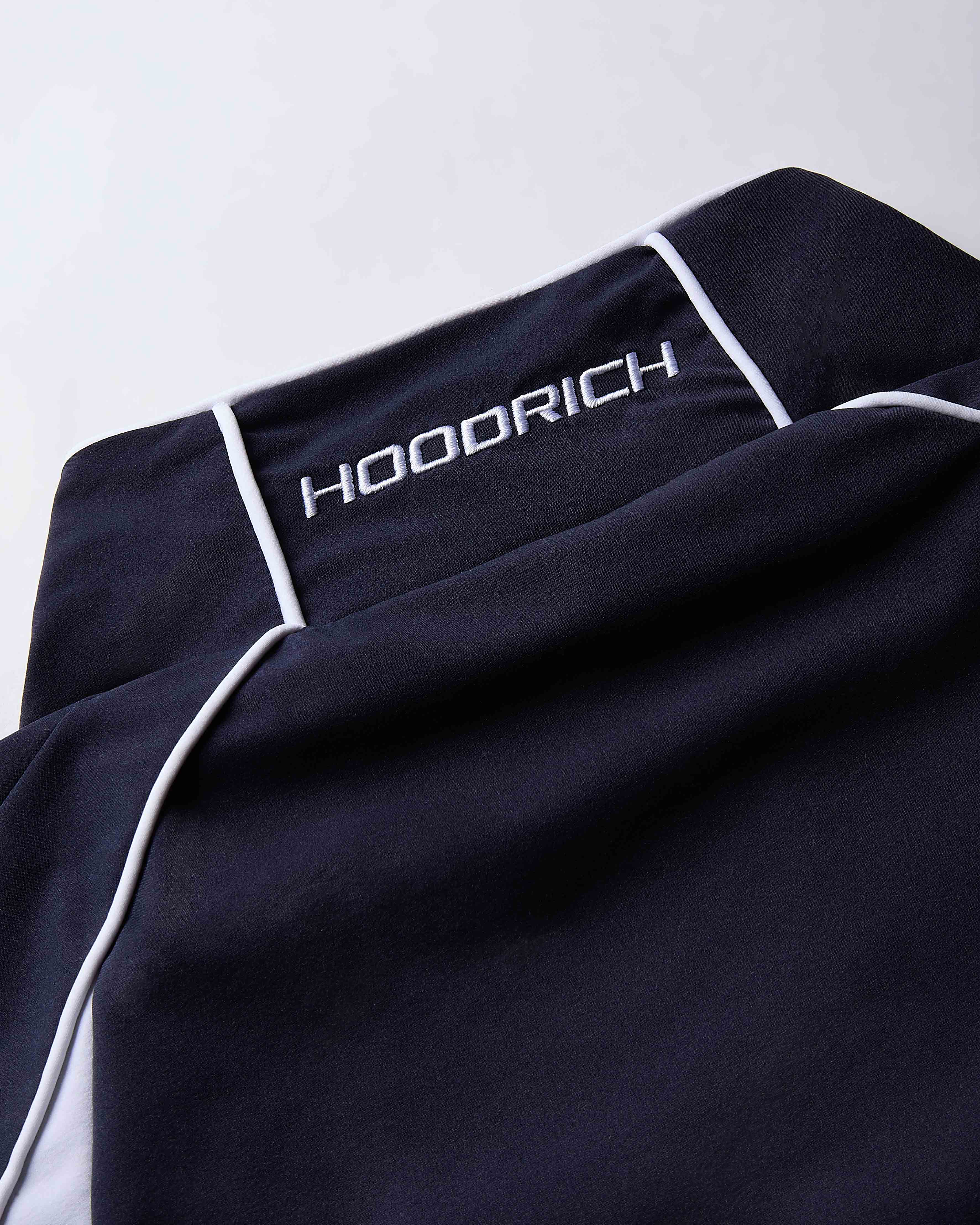 Black garment with 'HOODRICH' branding on a white background