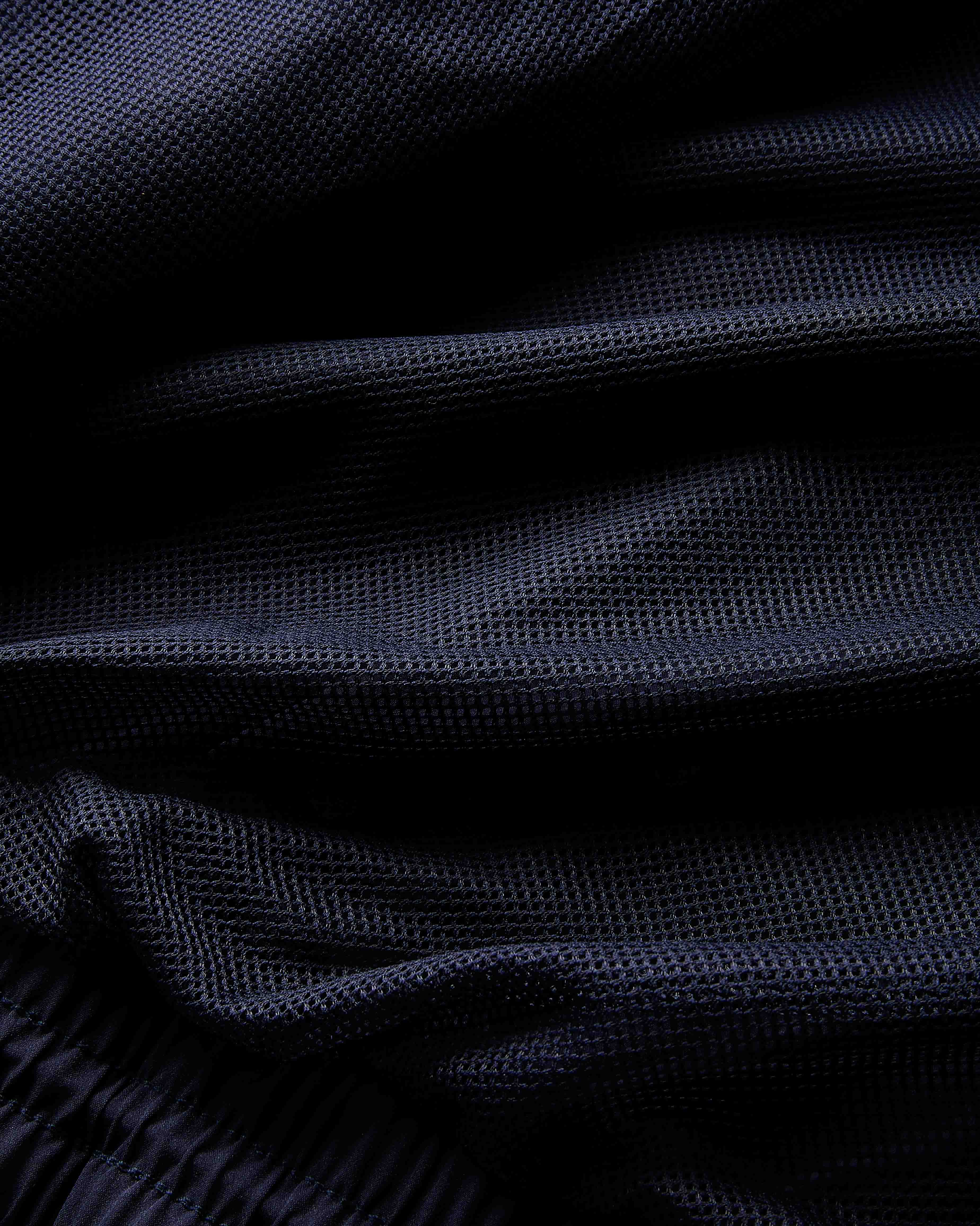 Close-up of dark blue fabric with a textured pattern