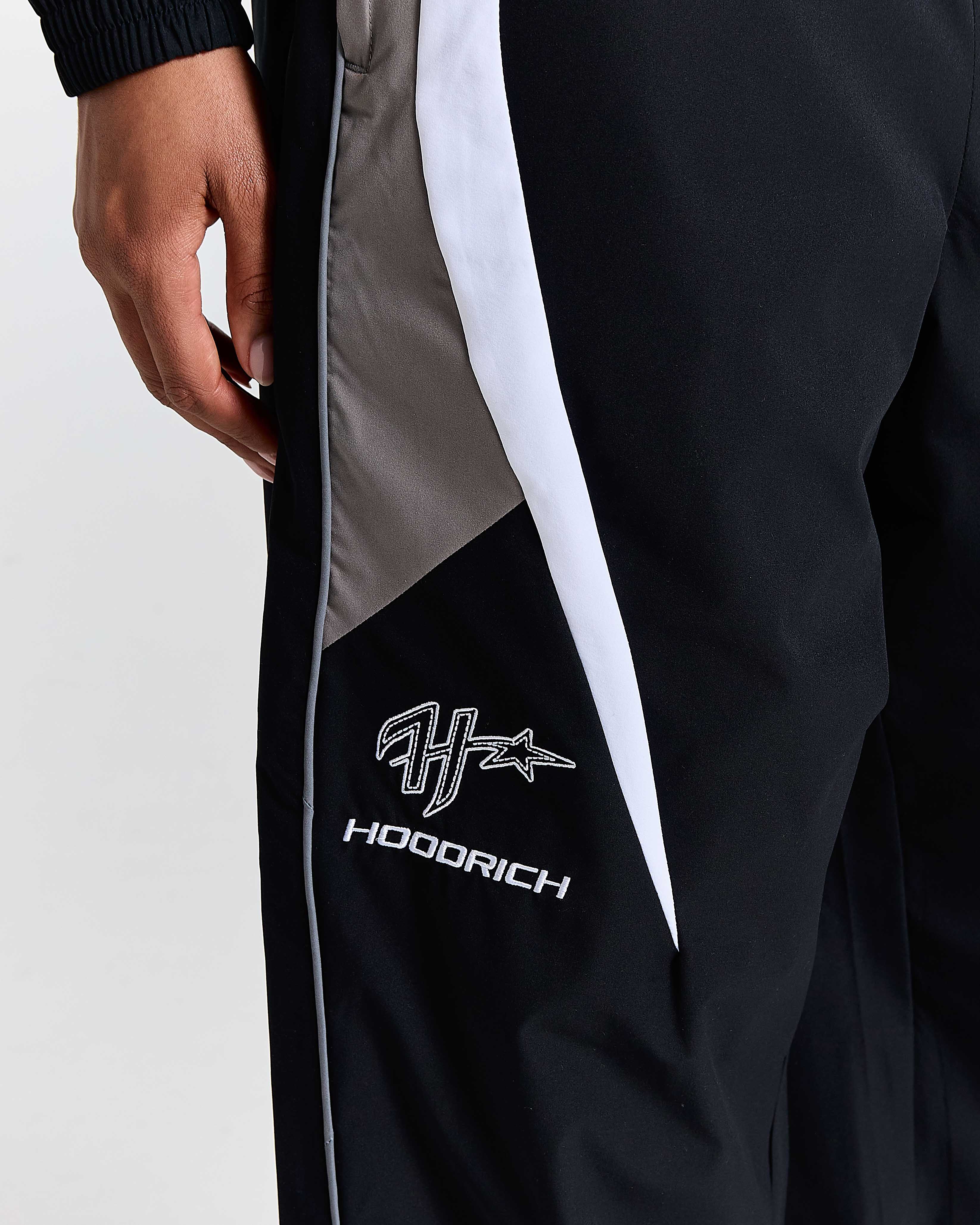 Black jacket with gray and white accents featuring the 'Hoodrich' brand logo.