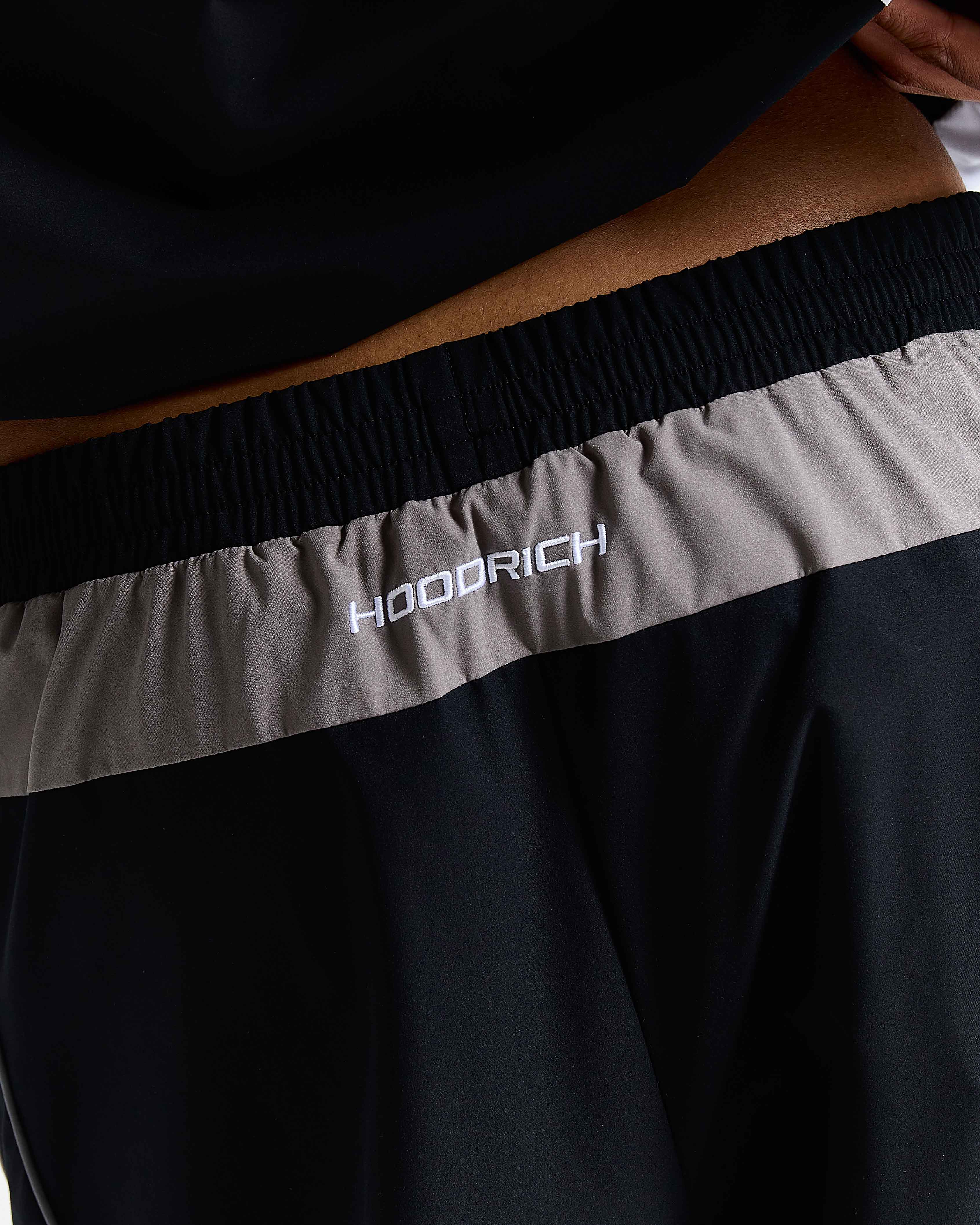 Black and gray jacket with 'HOODRICH' branding on the waistband.