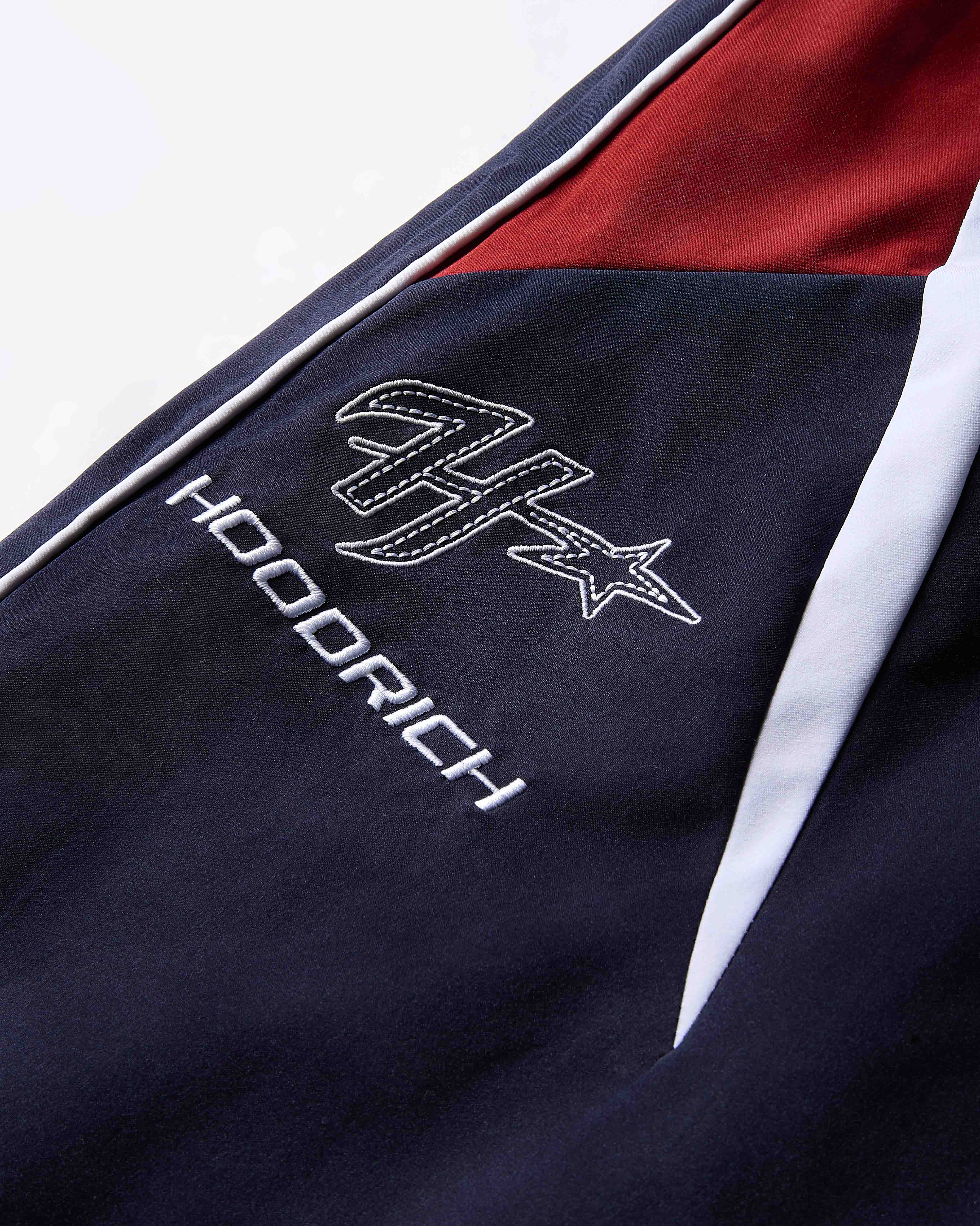 Navy blue jacket with white logo and text on a white background