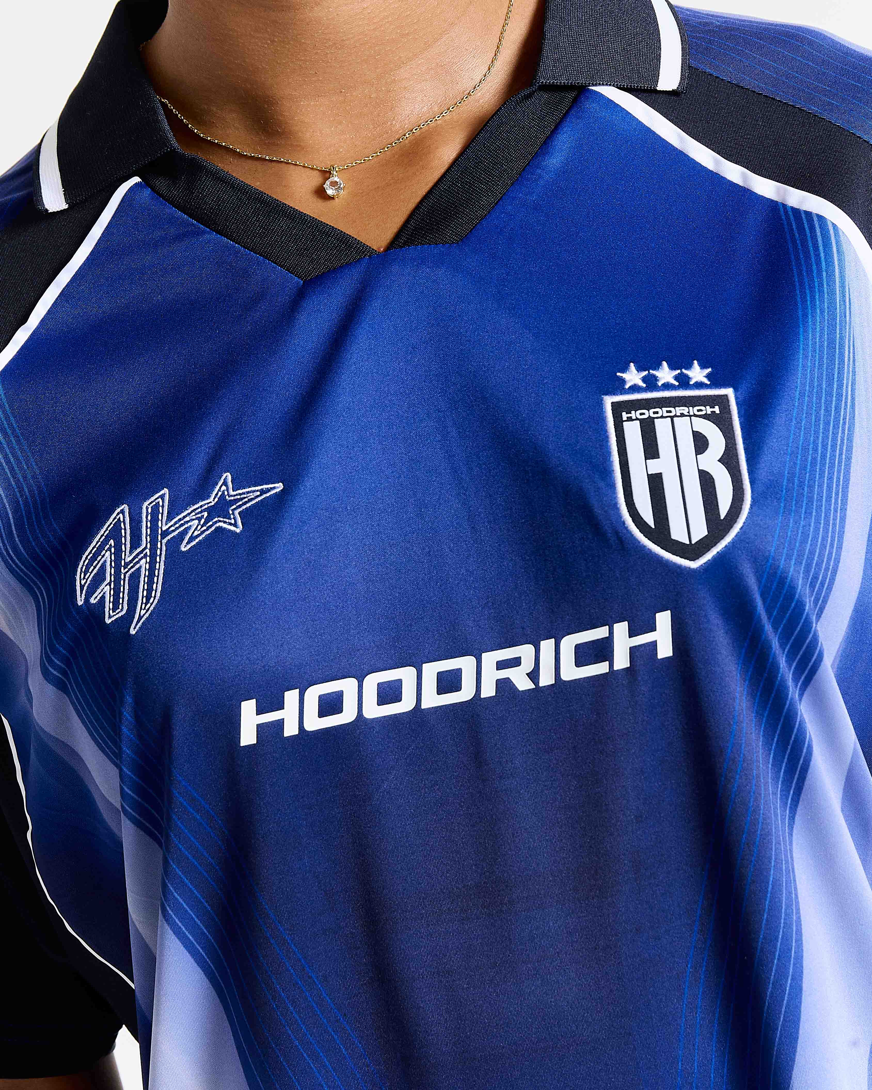 Blue sports jersey with 'Hoodrich' branding on a person wearing it.