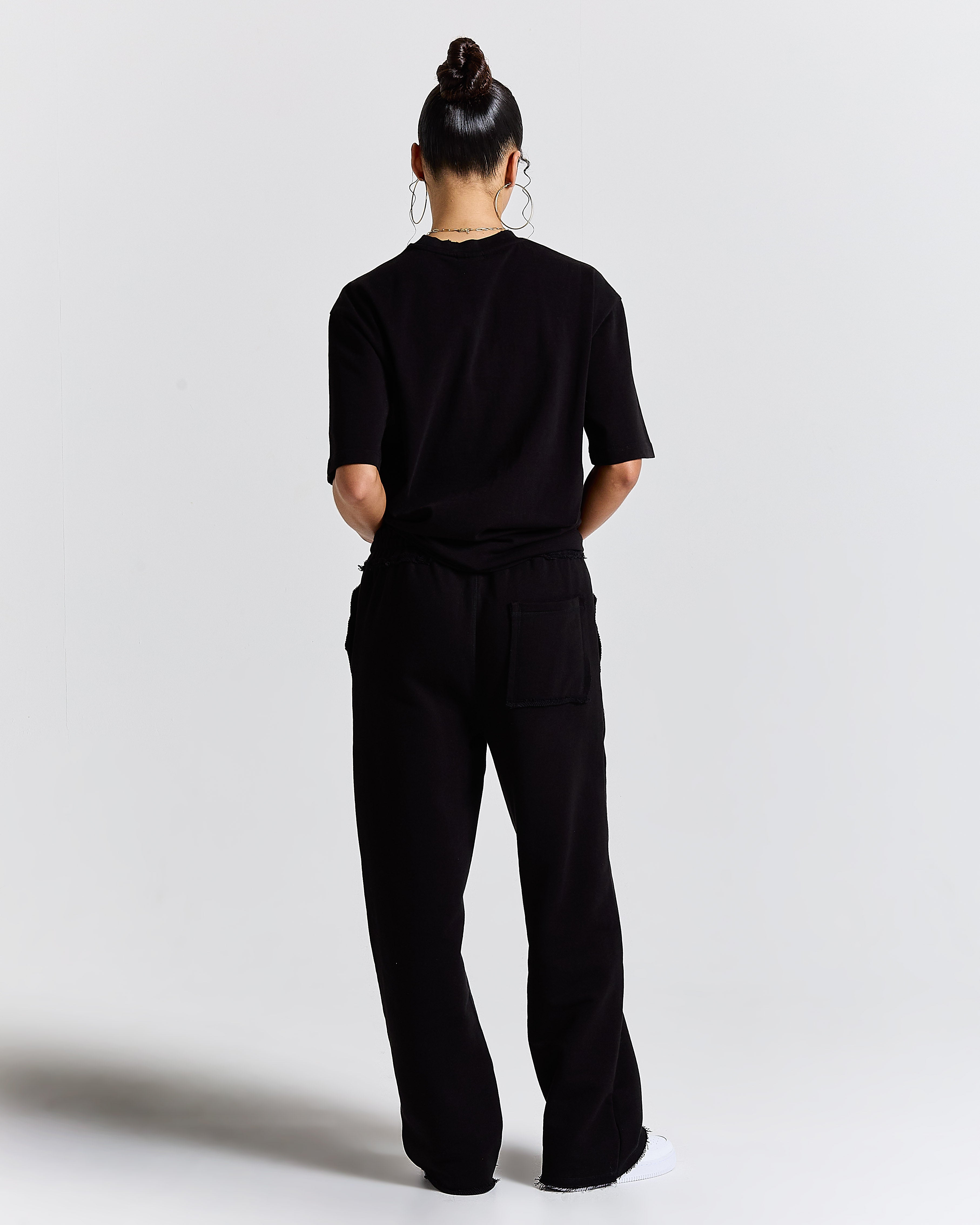 Person wearing a black outfit on a white background