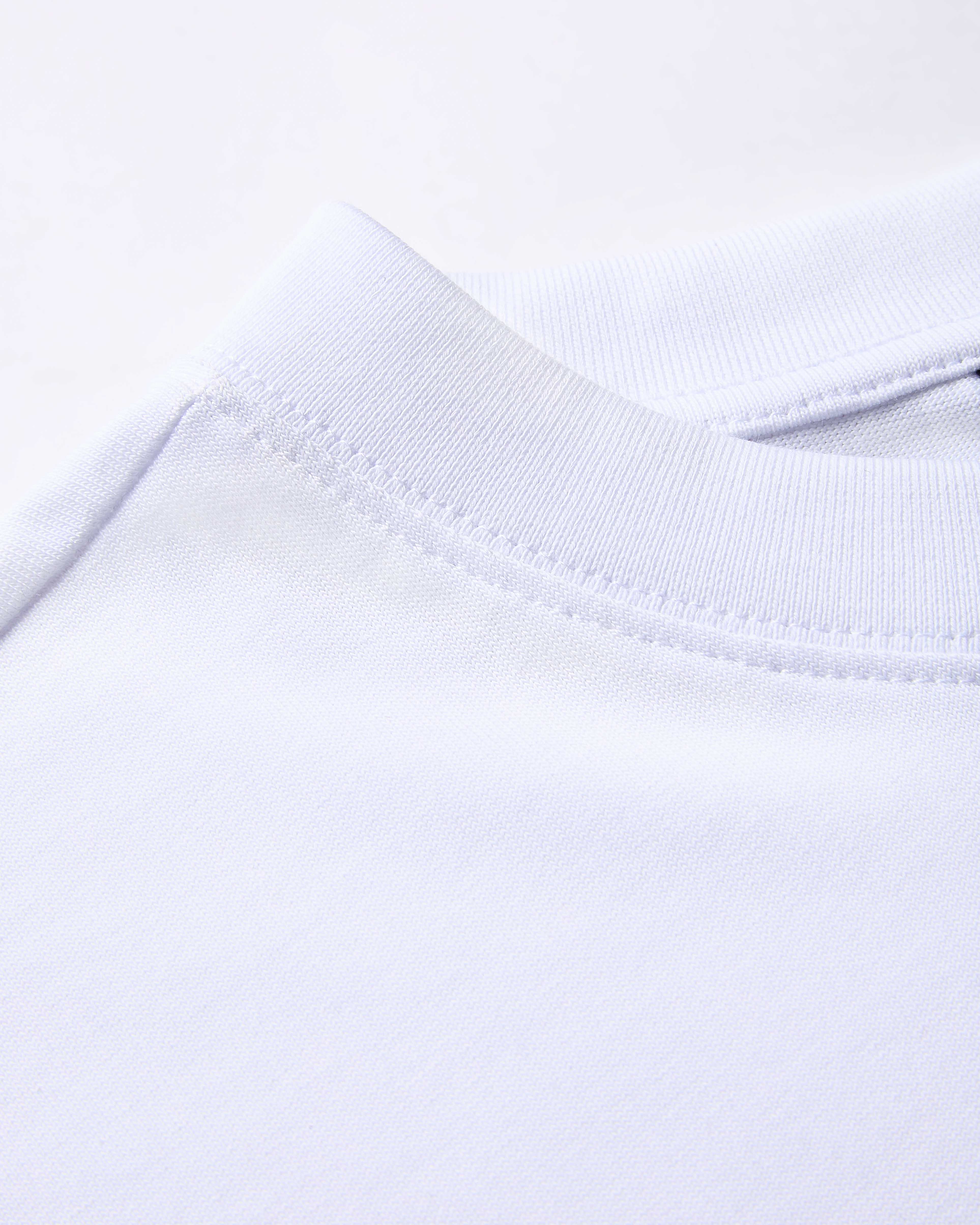 Close-up of a white fabric with a subtle pattern on a white background