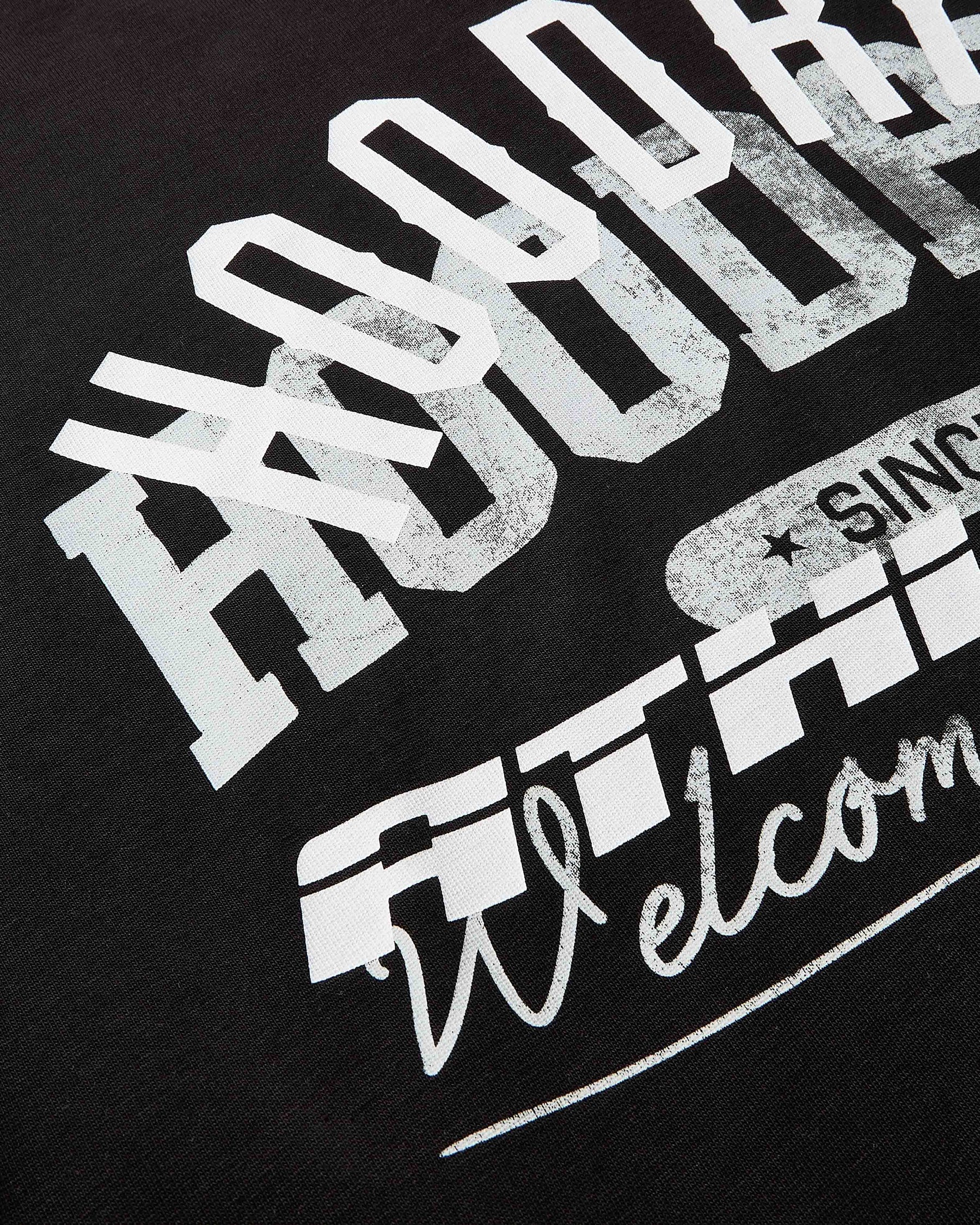 Black t-shirt with white and gray text design on a black background