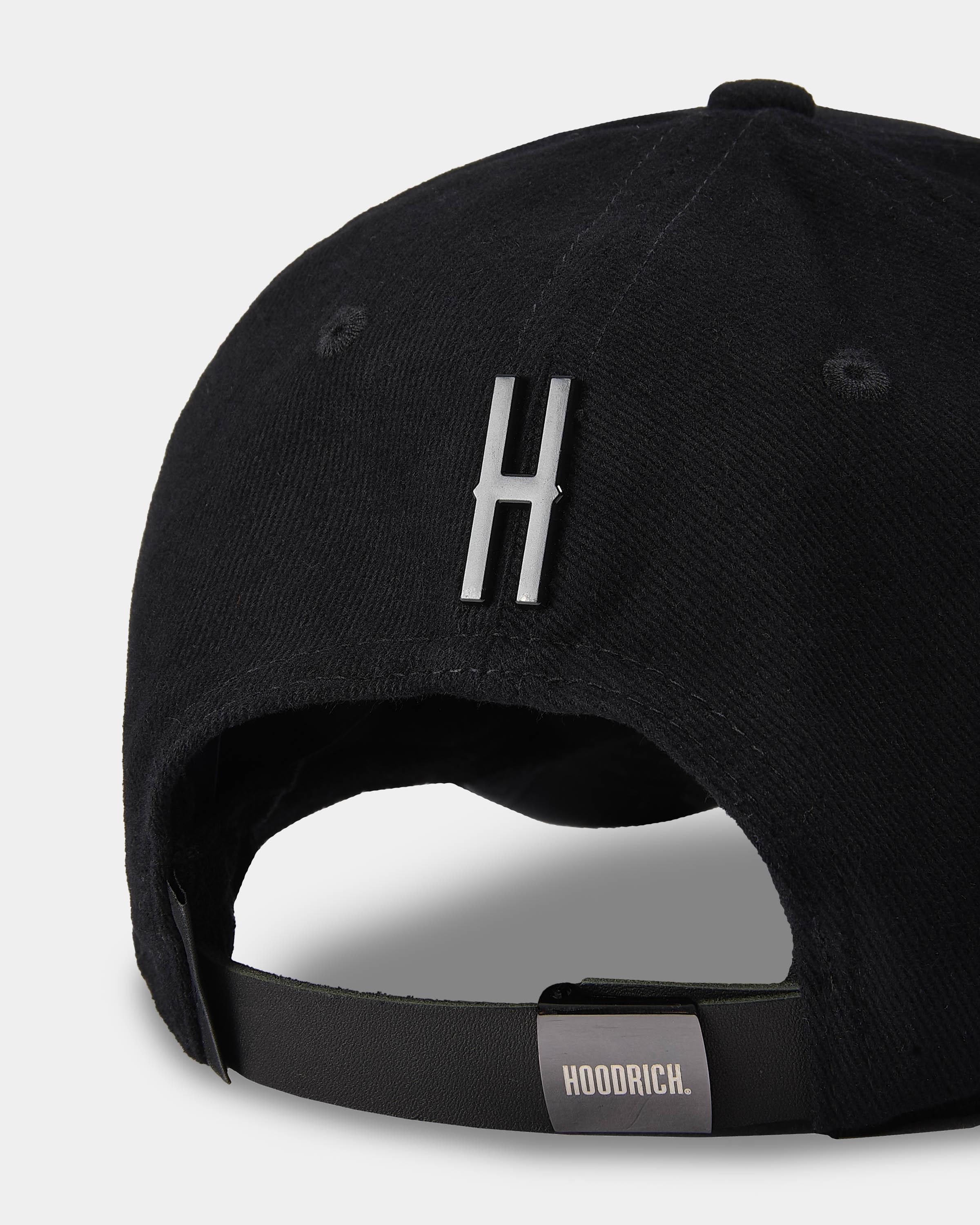 Black cap with a logo and 'HOODRICH' label on a light gray background