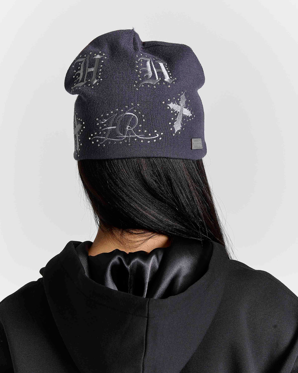 Displays a model wearing the grey 'Hoodrich' branded Scar Knitted Fitted Beanie