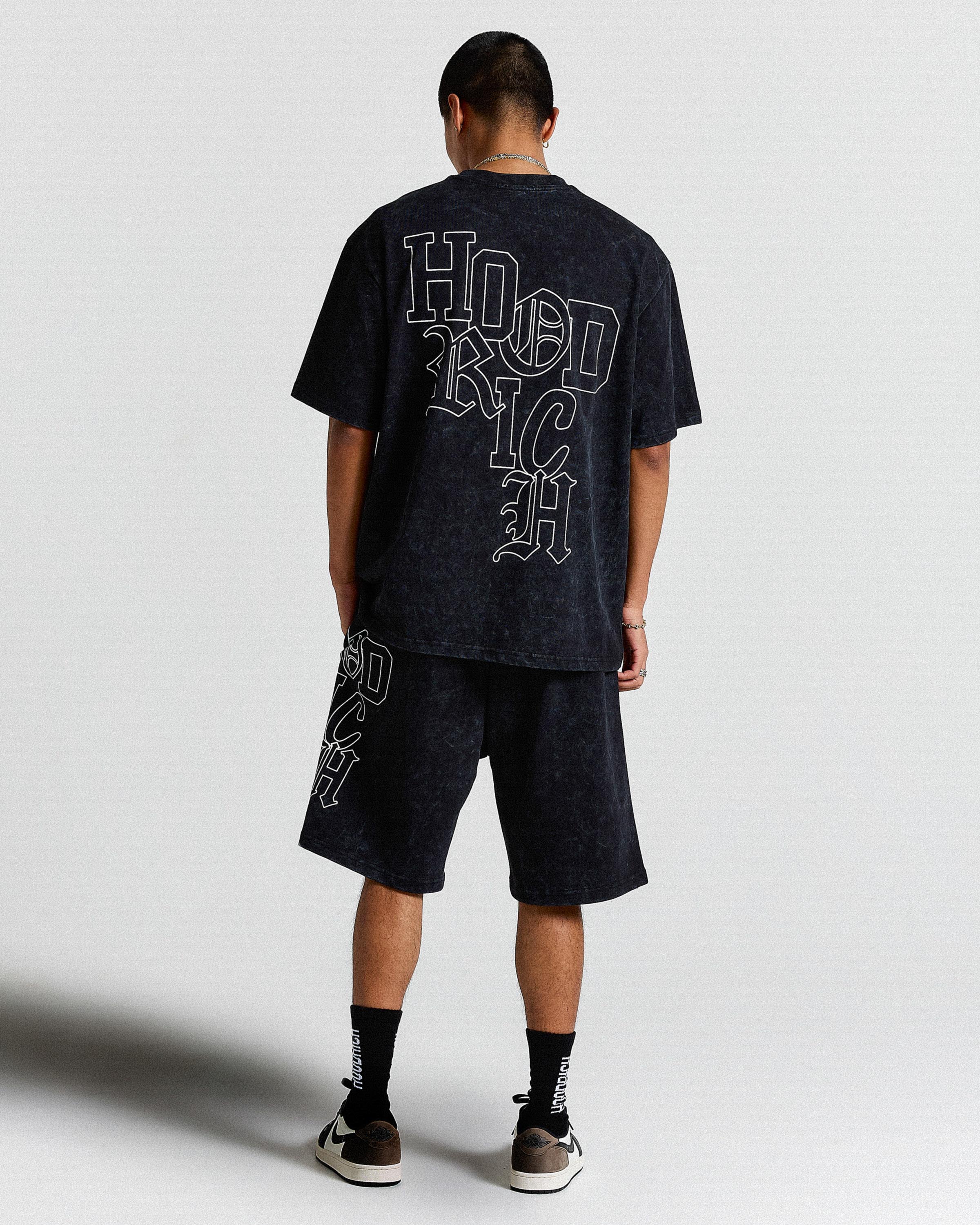 Person wearing a black t-shirt and shorts with 'HOOD RICH' branding on a white background