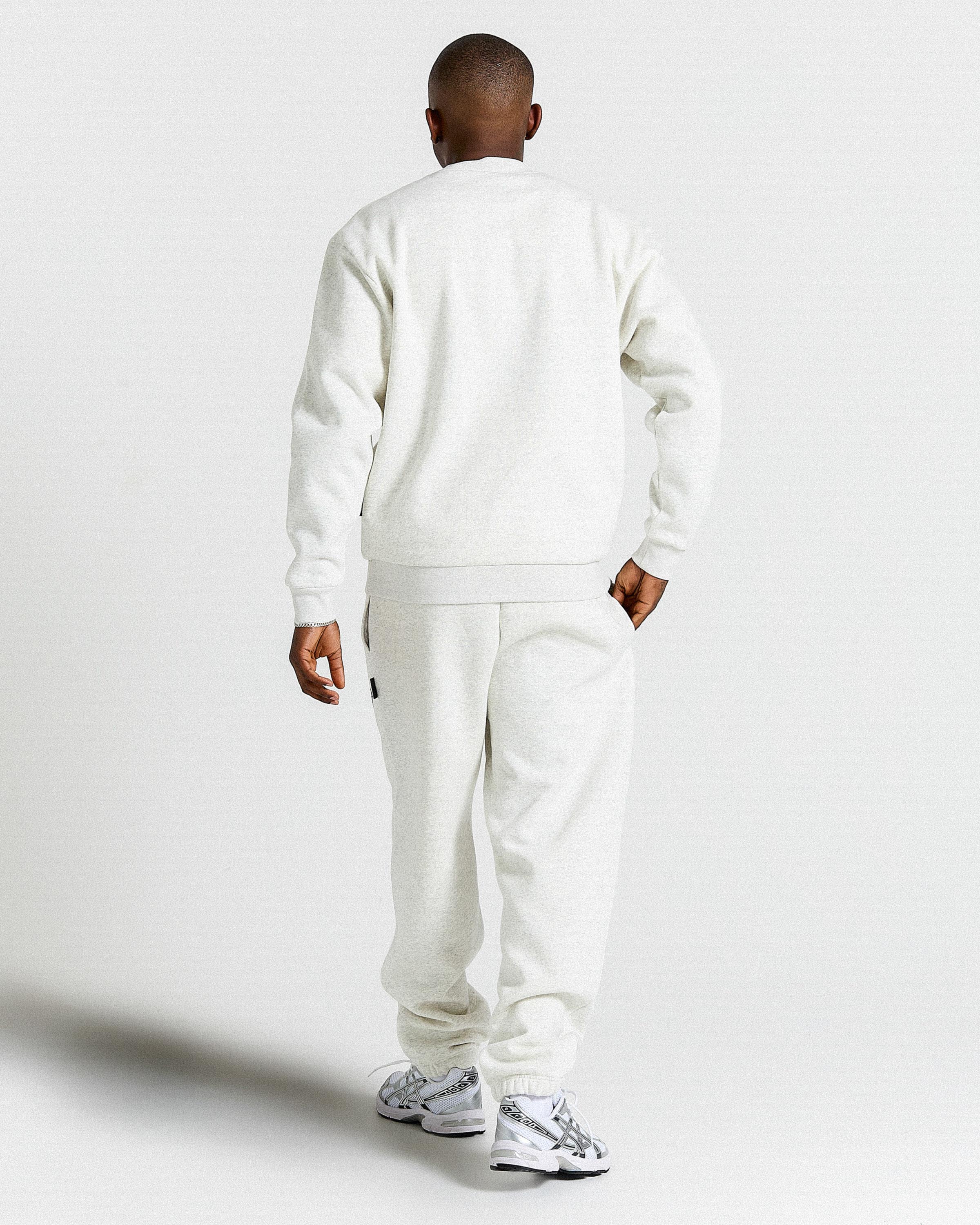 Displays a model wearing the Grey & Black 'Hoodrich' branded men's Rivet Full Tracksuit 