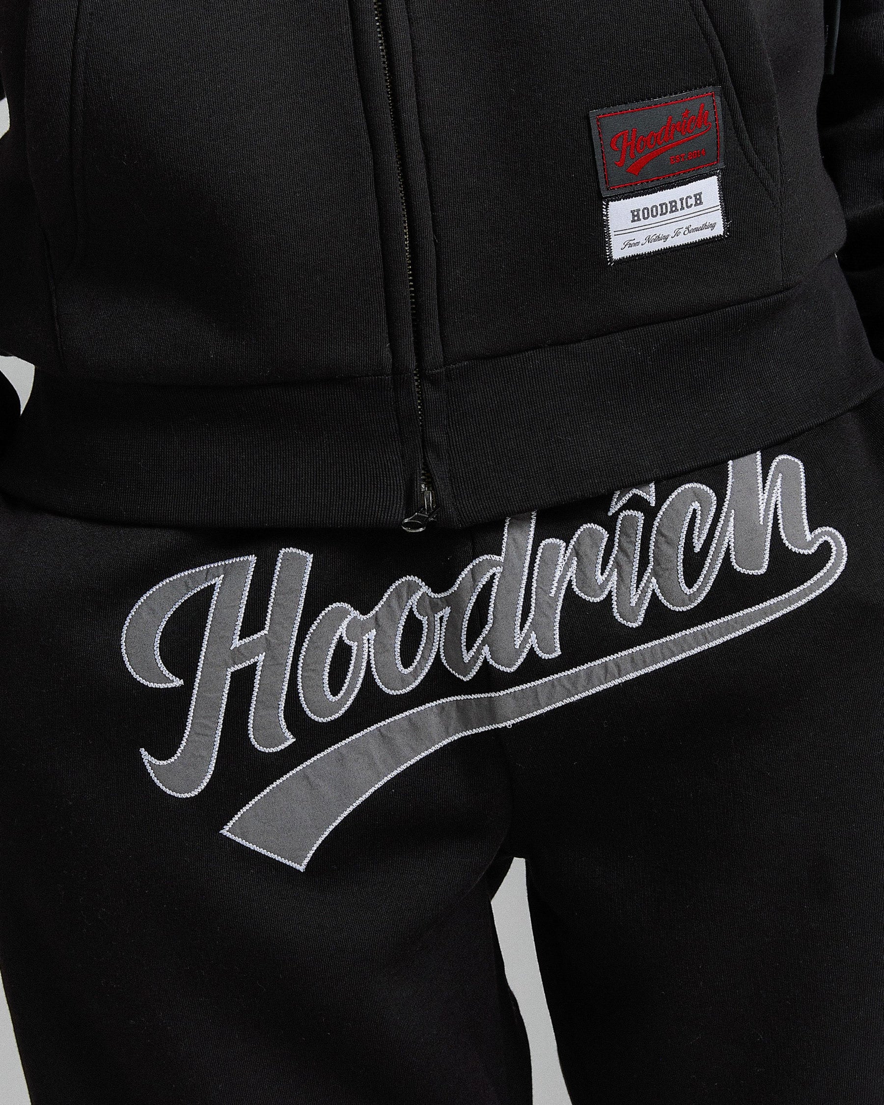 Black hoodie with 'Hoodrich' branding on a plain background