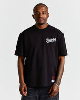 Man wearing a black t-shirt with a logo on a white background