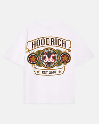 A white short-sleeve t-shirt with a large graphic print on the front. The graphic features the word 'HOODRICH' in a banner above a circular emblem with the brand's logo, flanked by two star circles, and 'EST 2014