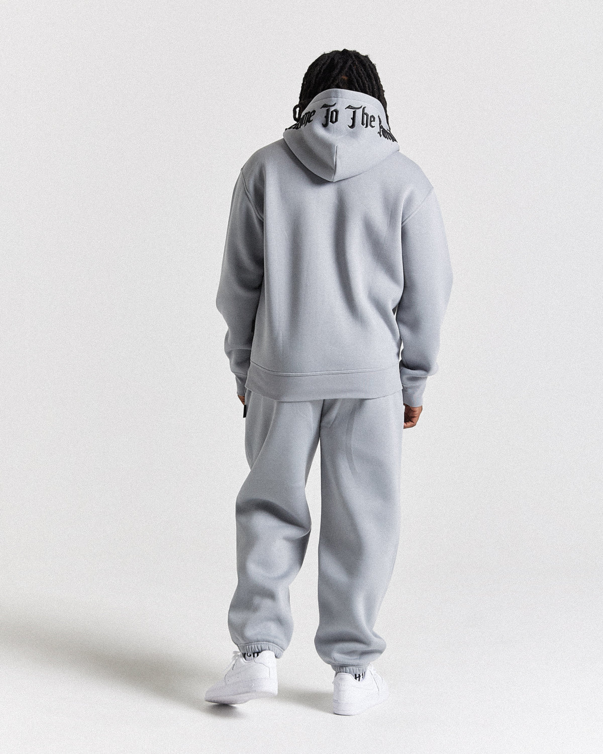 Displays a model wearing the Grey 'Hoodrich' branded men's Dark Full Tracksuit 