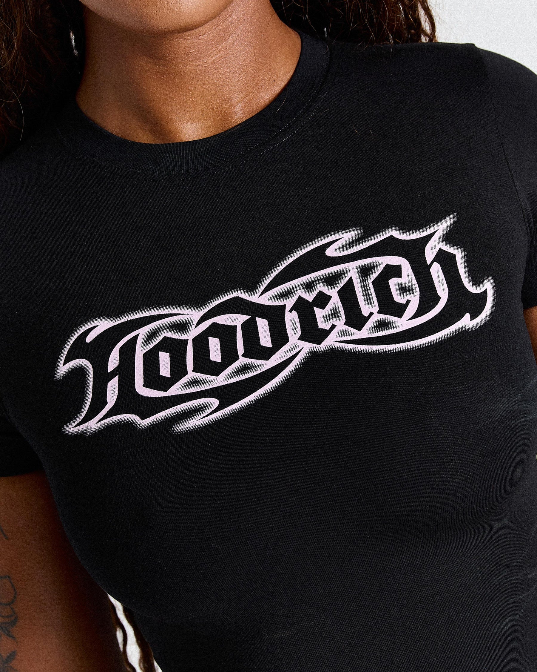 Black t-shirt with white graphic design on a person wearing it.