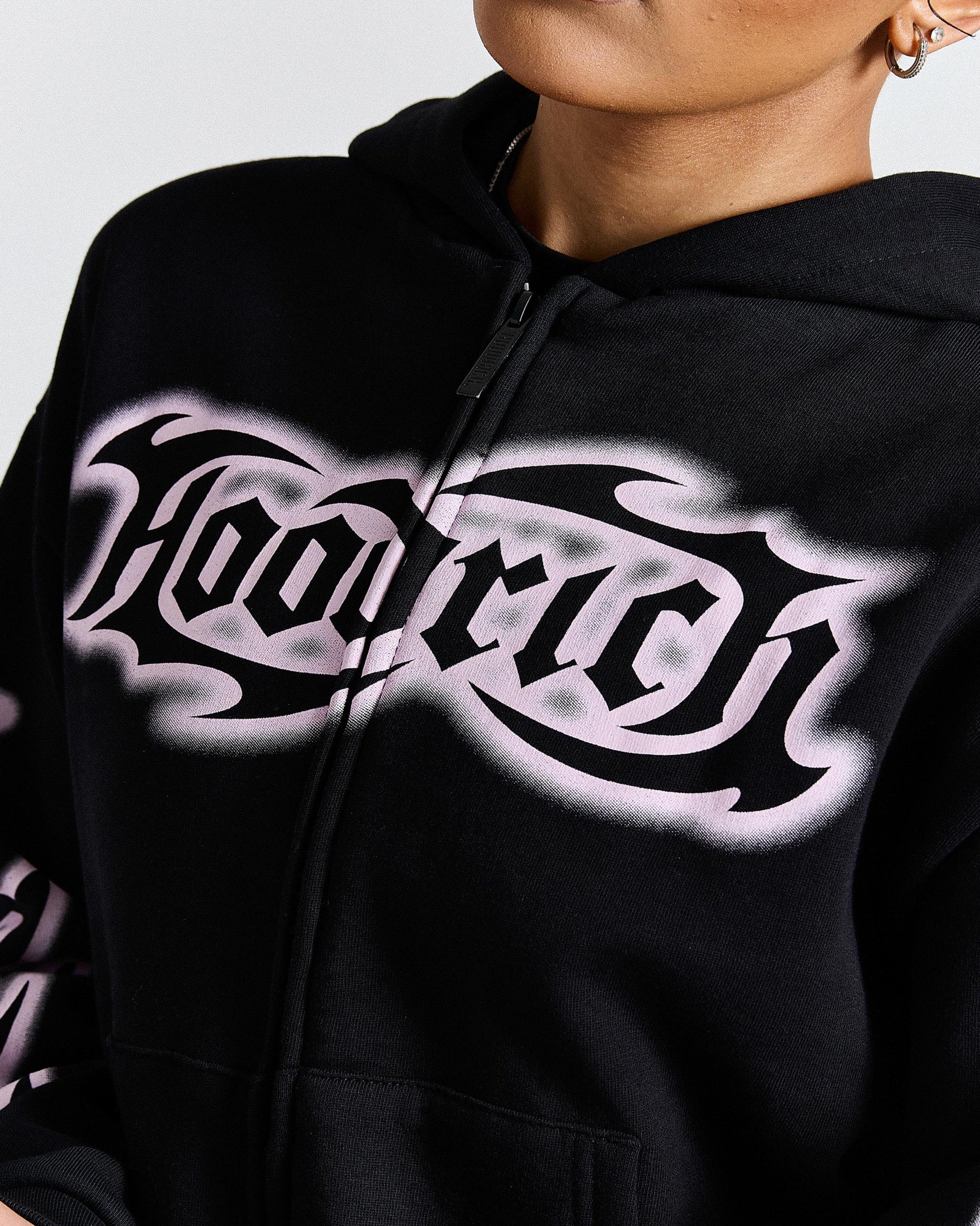 Black hoodie with white graphic design on a plain background