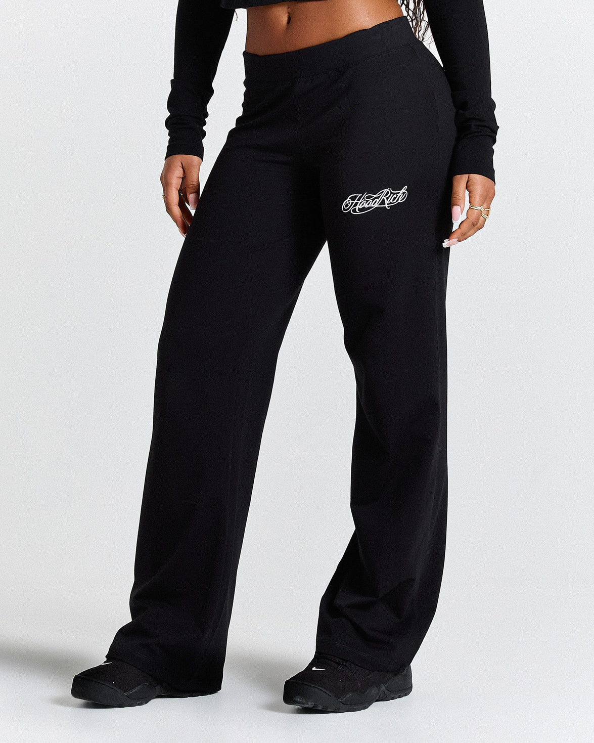 Black sweatpants with a logo on a white background