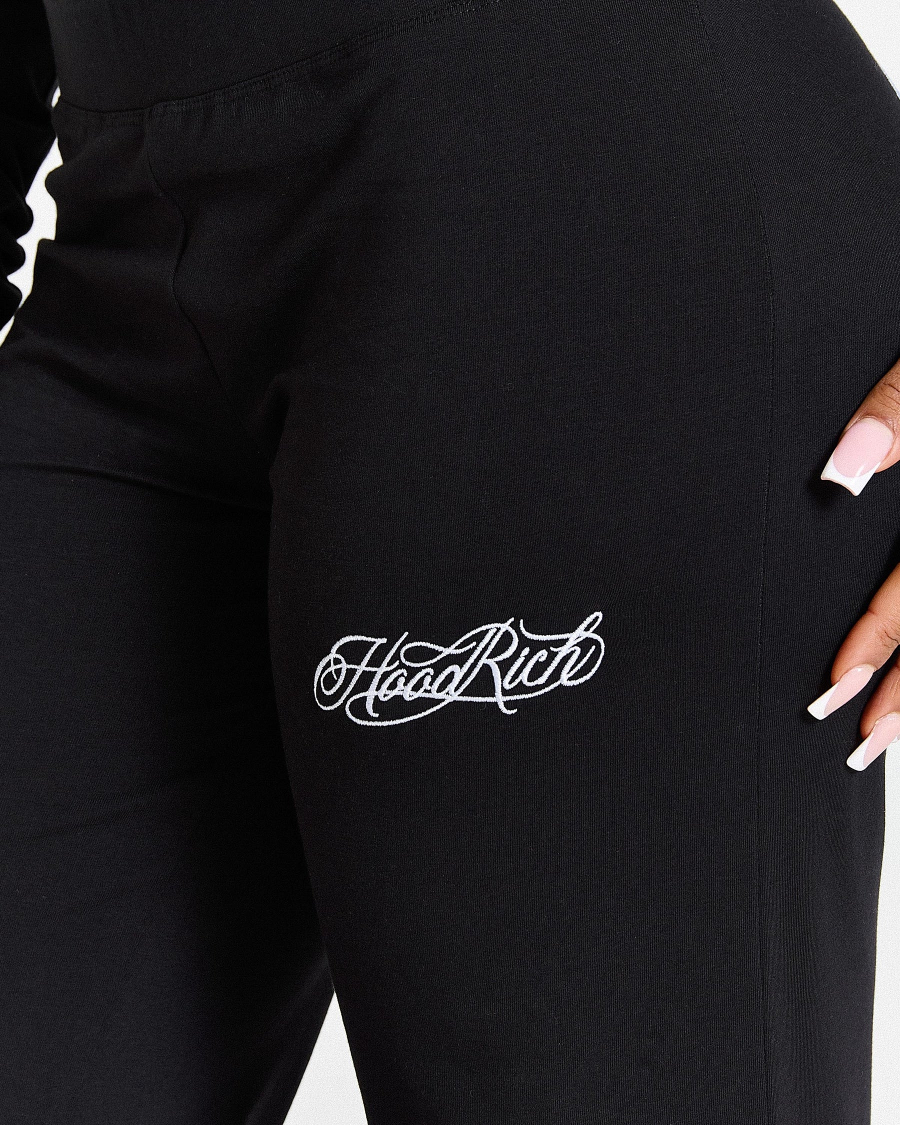 Black pants with 'Hood Rich' logo on a white background