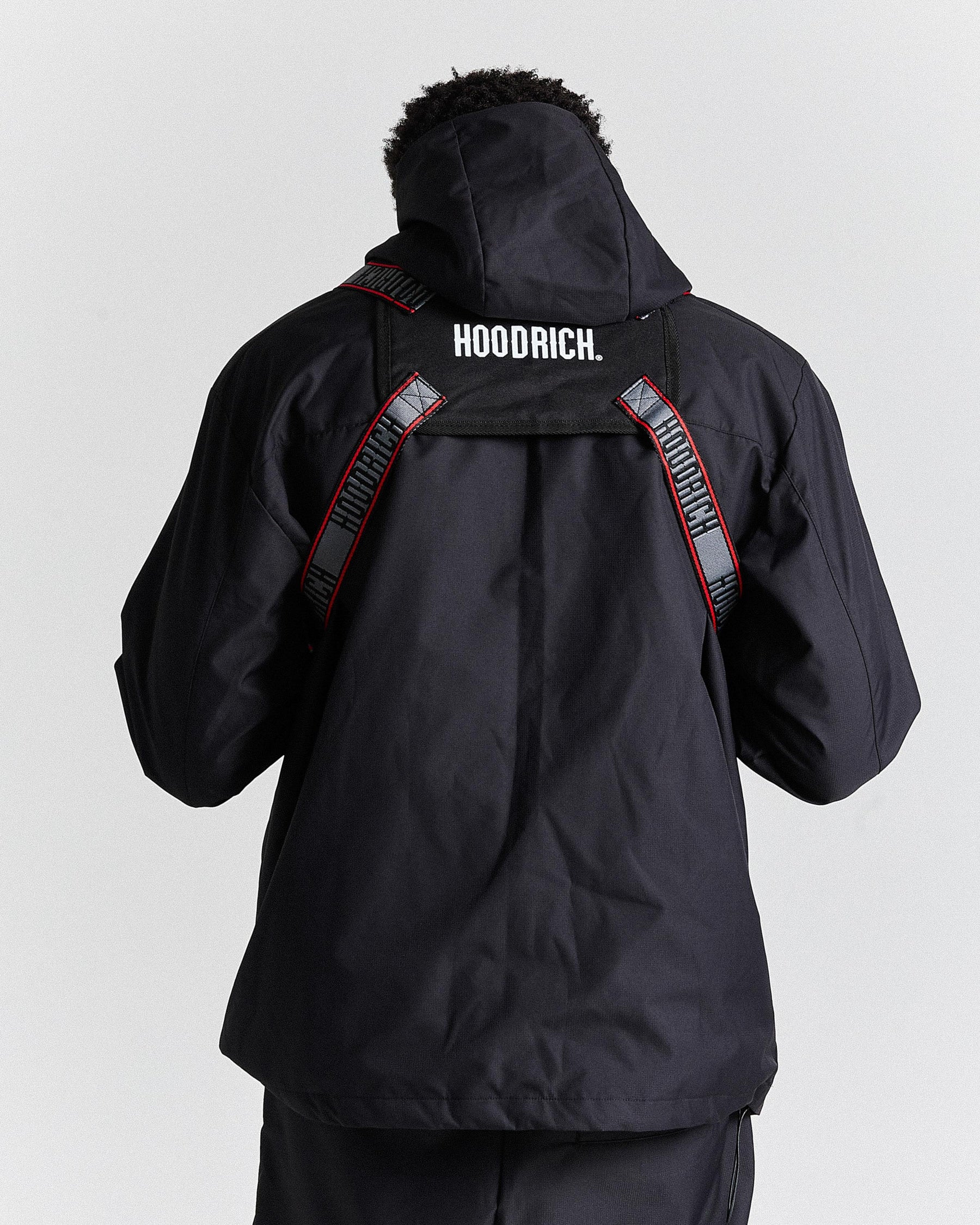 Black jacket with 'HOODRICH.' branding on a white background