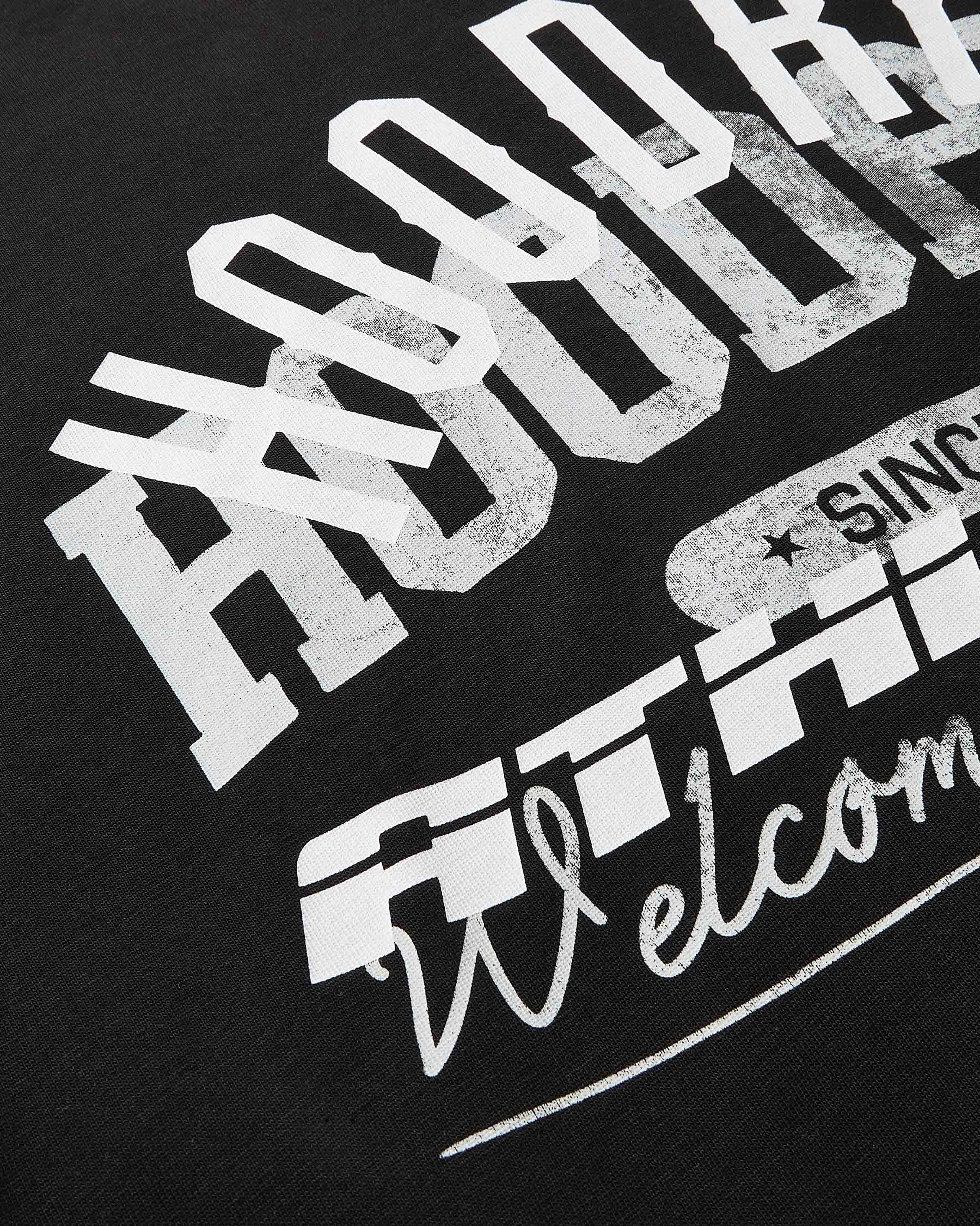 Black t-shirt with white and gray text design on a black background