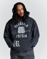 Person wearing a dark hoodie with text and graphics on a white background