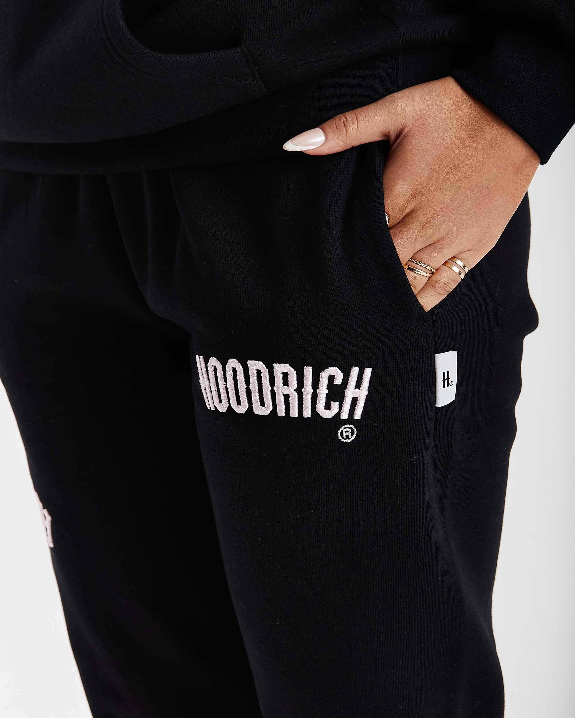 Black sweatpants with 'Hoodrich' branding on a white background