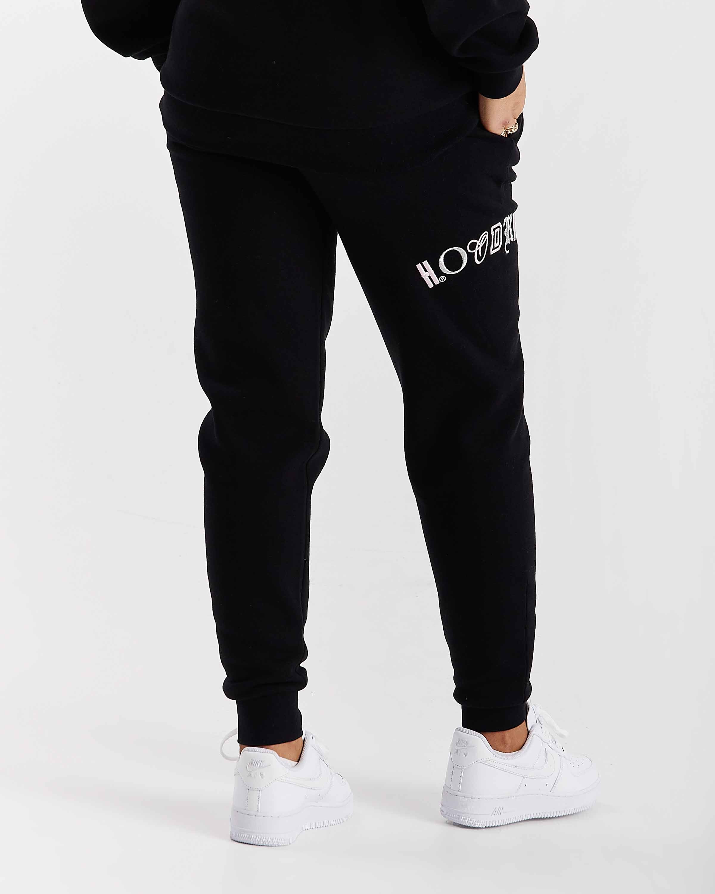 Black jogger pants with white text on a white background